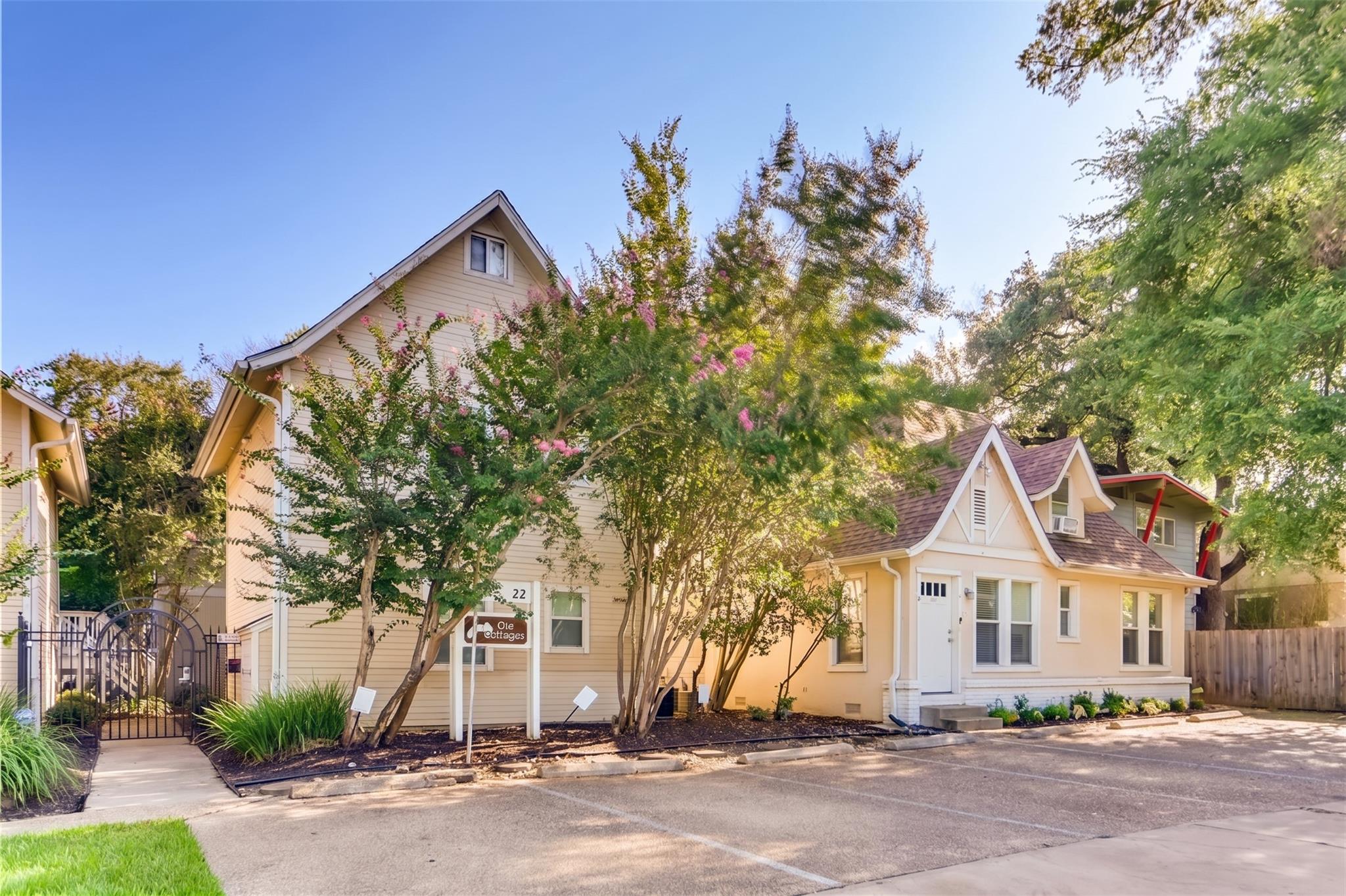 Mature trees shade the classic siding and gabled 