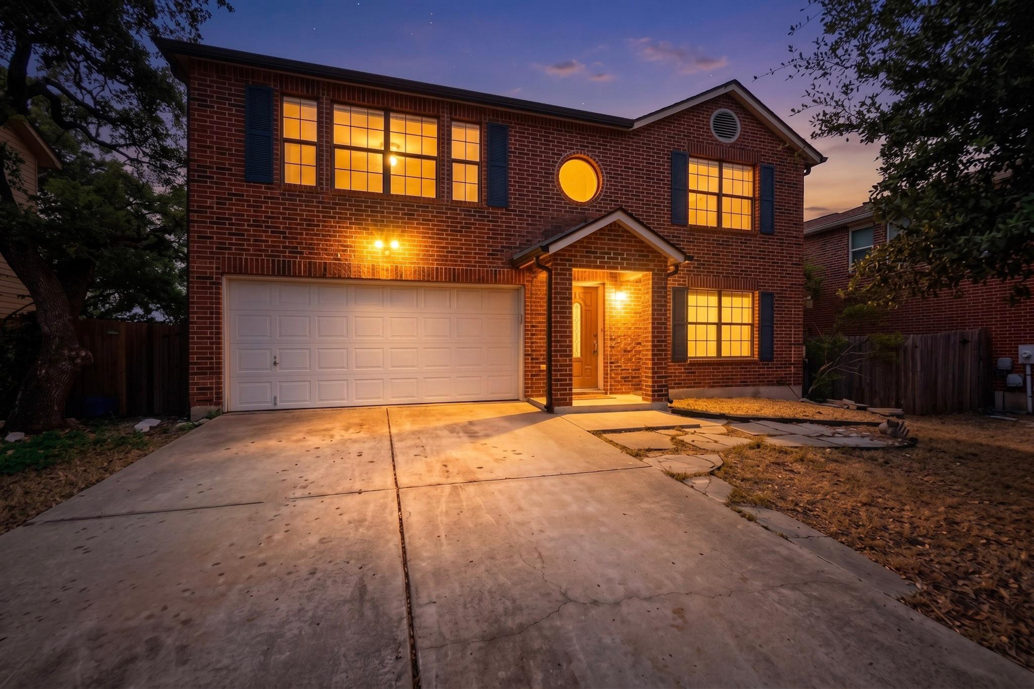 Warmly lit windows illuminate the classic brick f