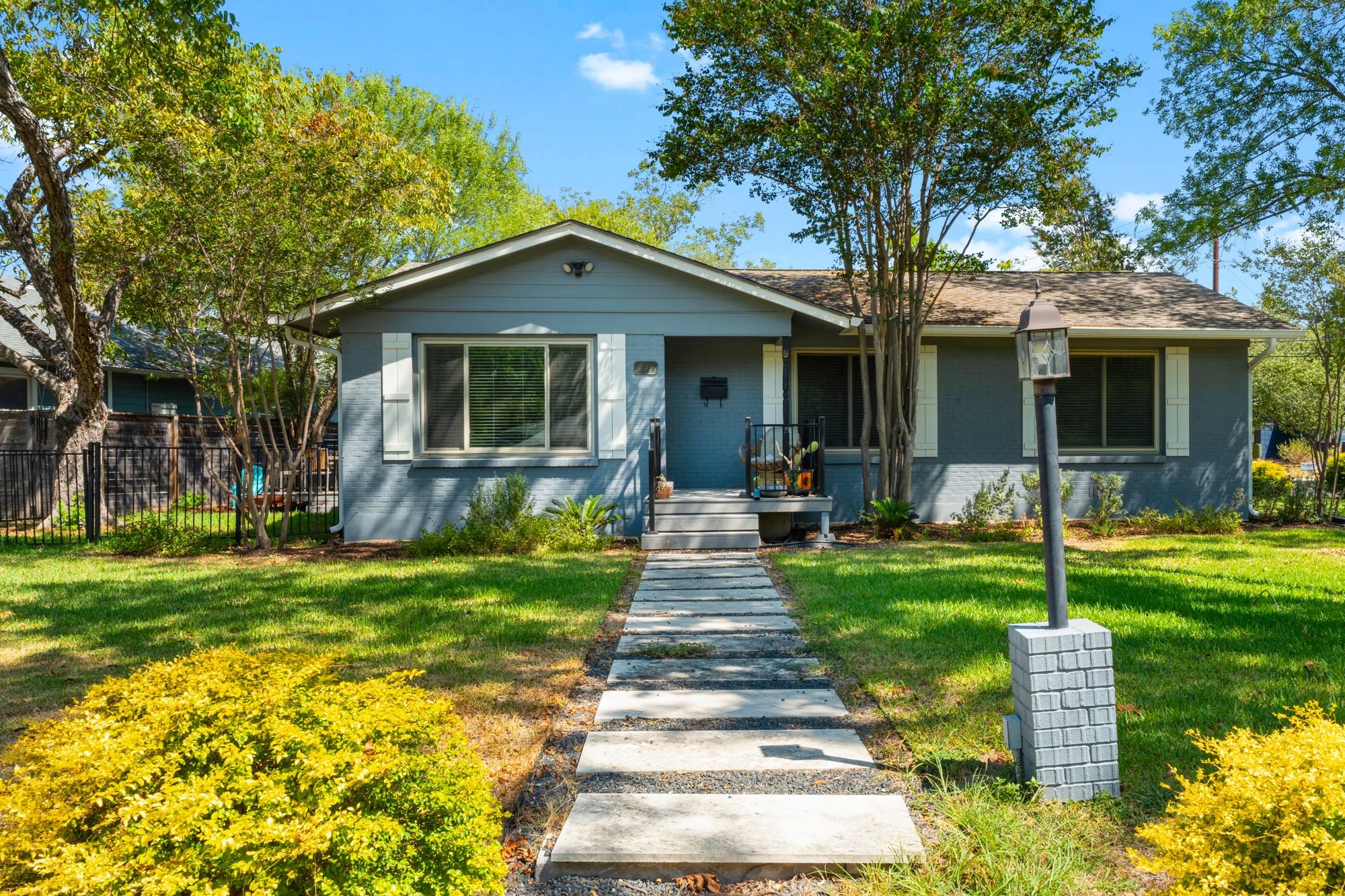 A stone walkway leads to this classic single-stor