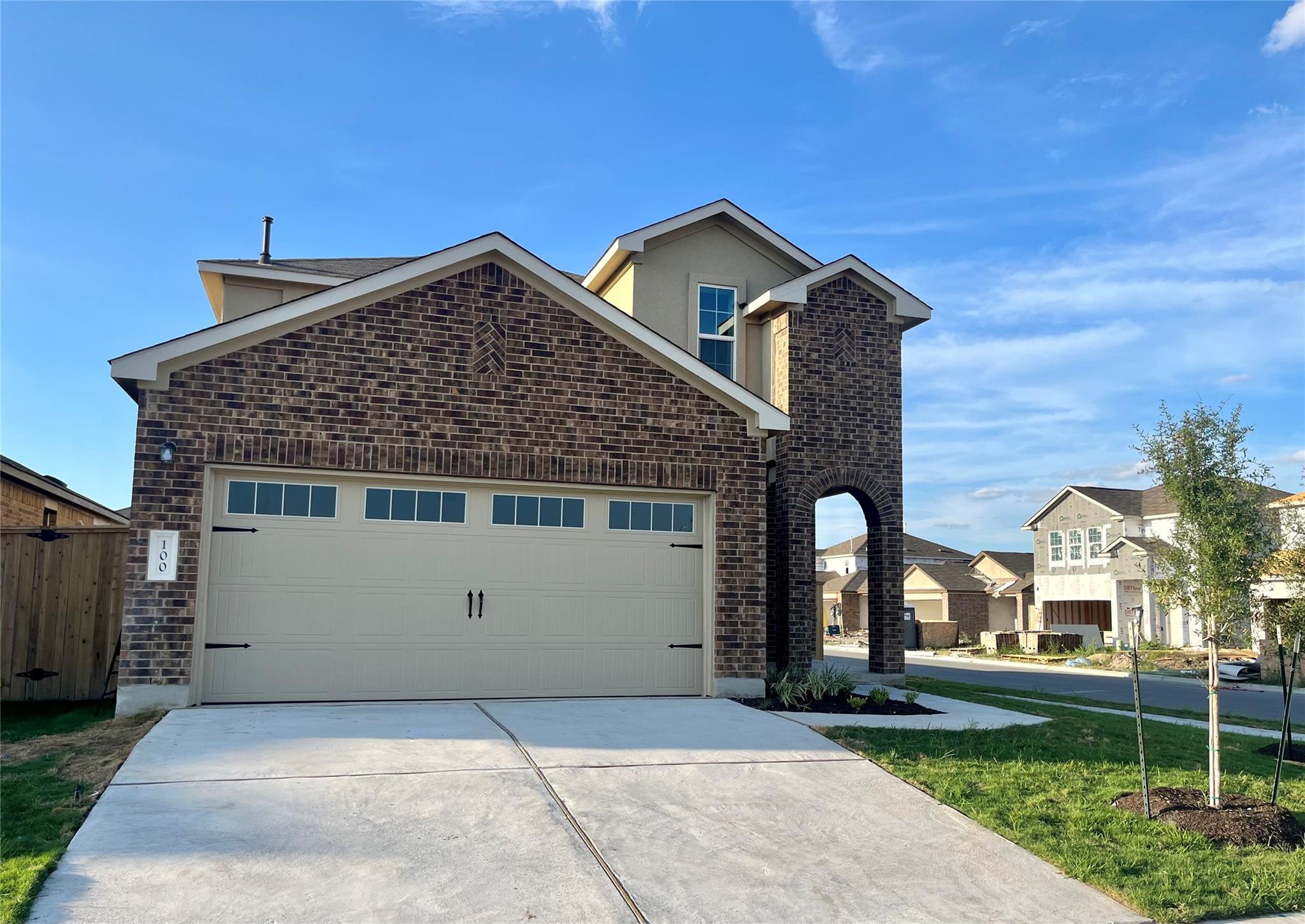 Timeless brick masonry and a concrete driveway de