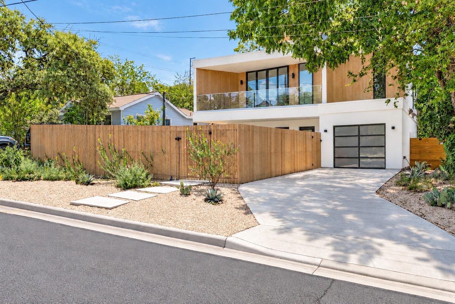 A concrete driveway leads to this contemporary ho