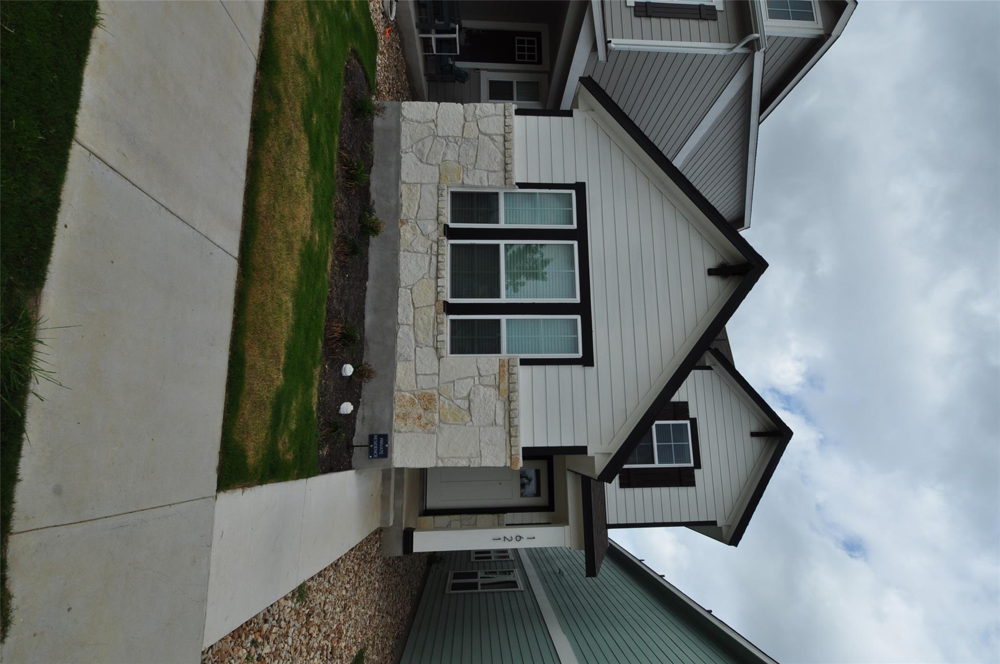 Crisp white siding complements the textured stone