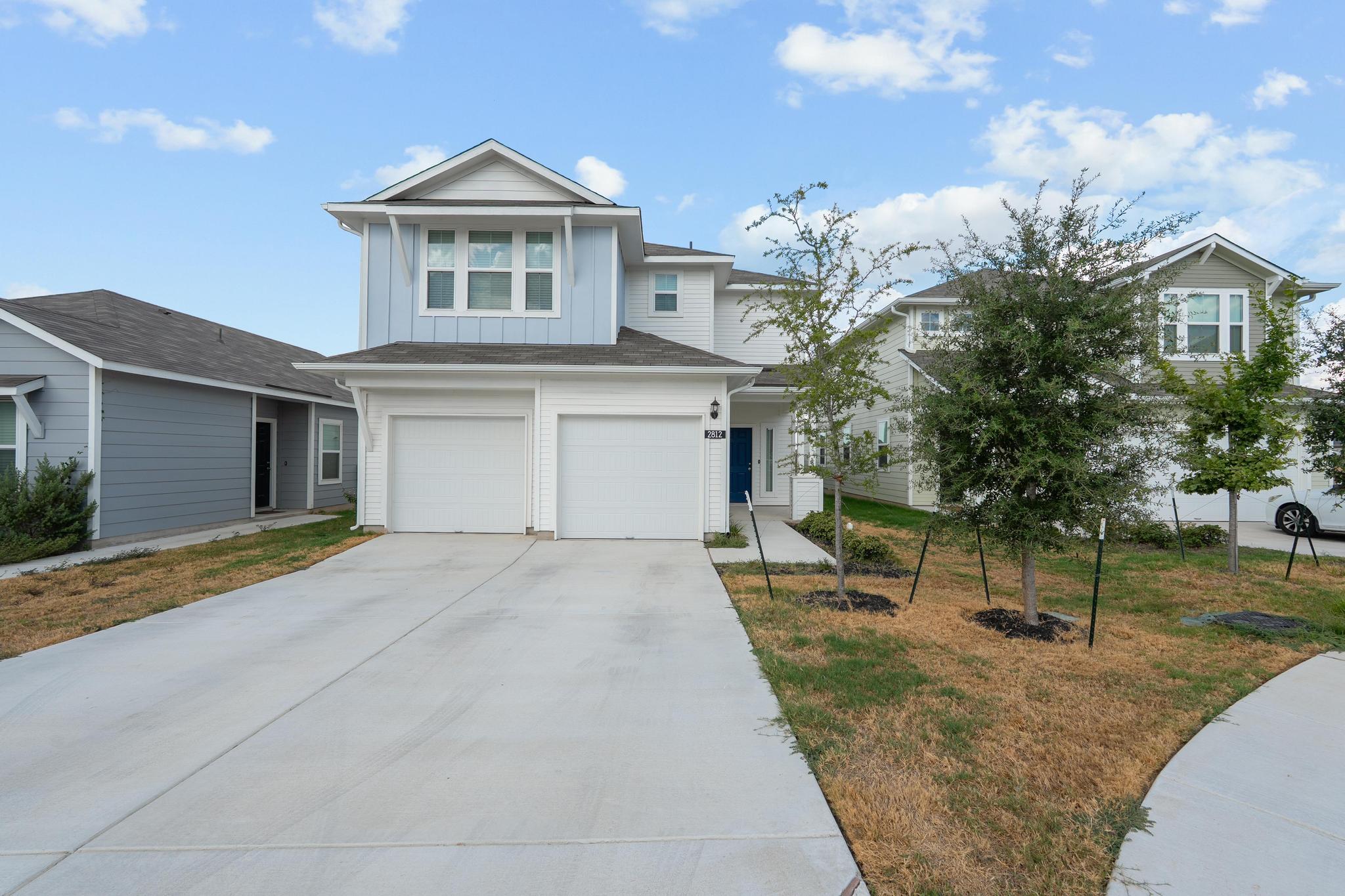 Clean lines and a spacious concrete driveway high