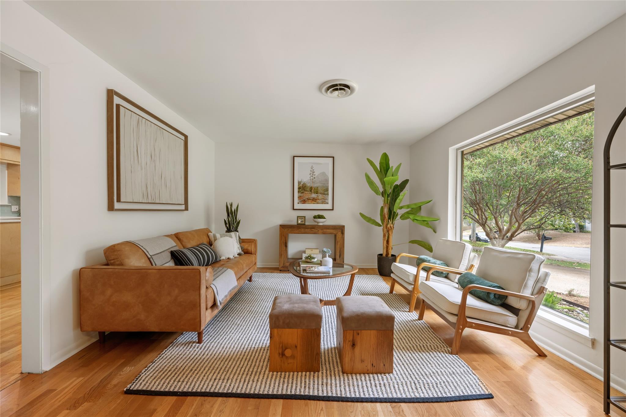 Rich hardwood floors and a picture window overloo