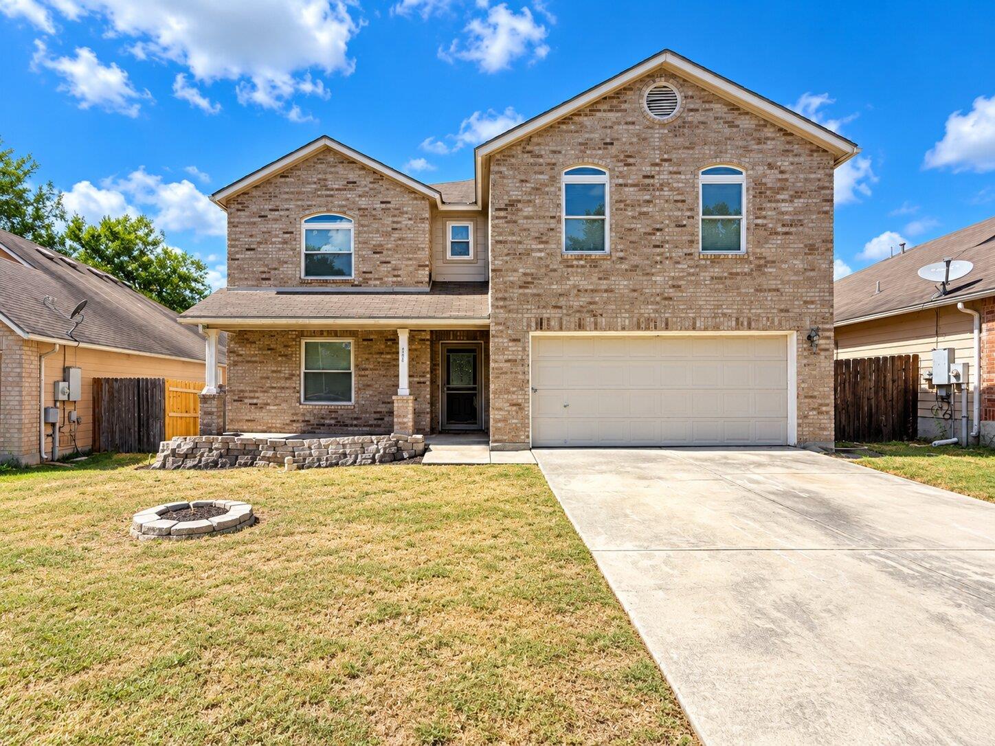 A classic brick exterior matches a spacious concr