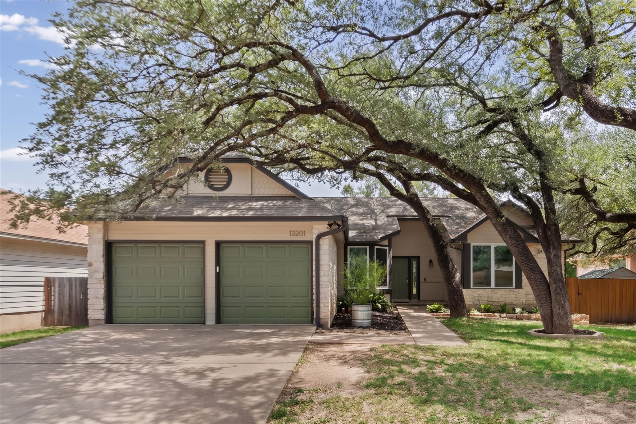 Mature shade trees frame a charming exterior with