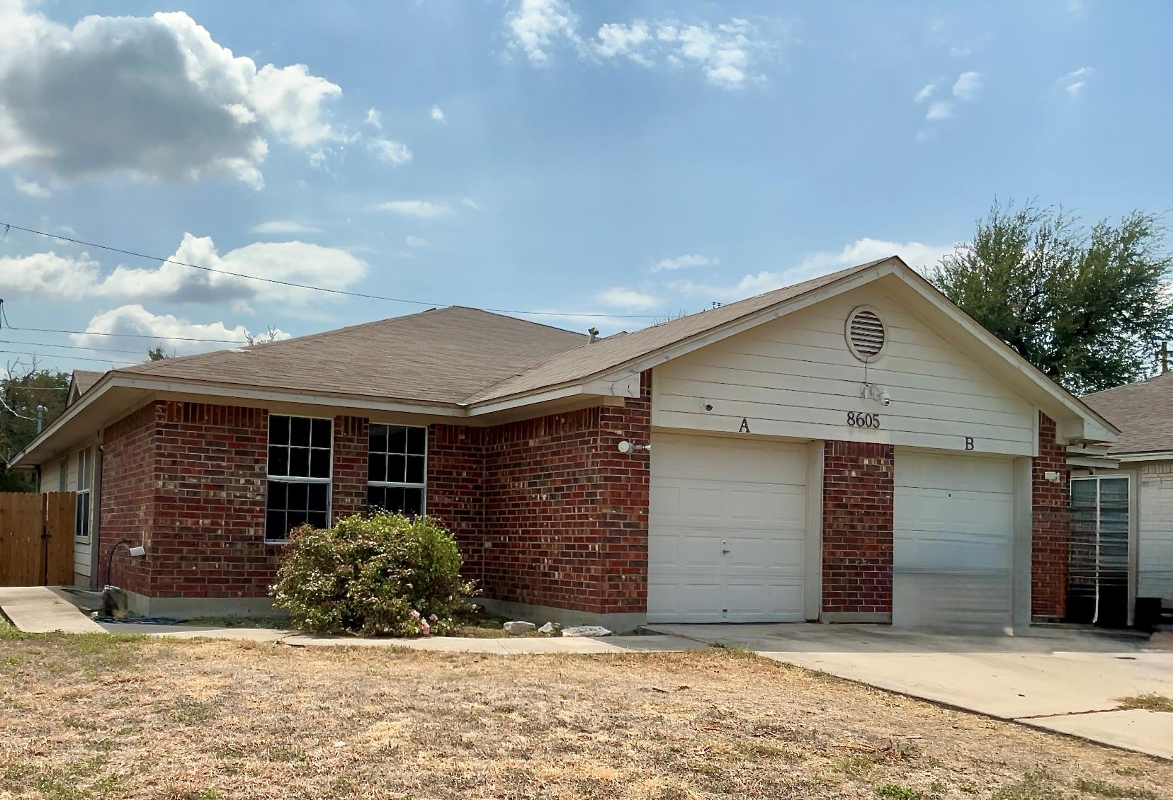 Classic brick accents and a multi-car garage defi
