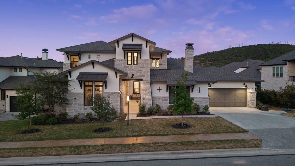 An elegant stone facade stands out against manicu