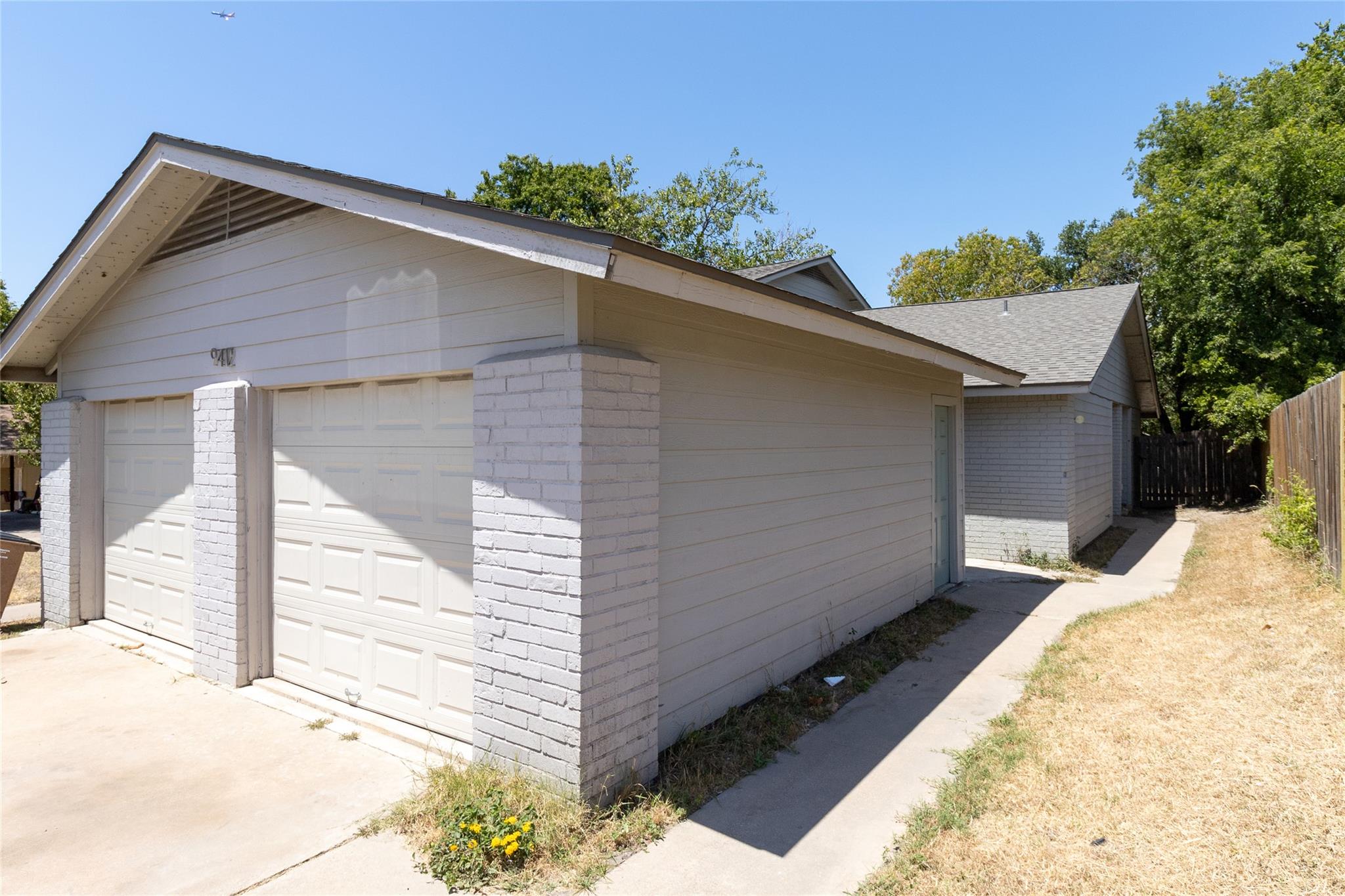 An attached multi-car garage provides convenient 