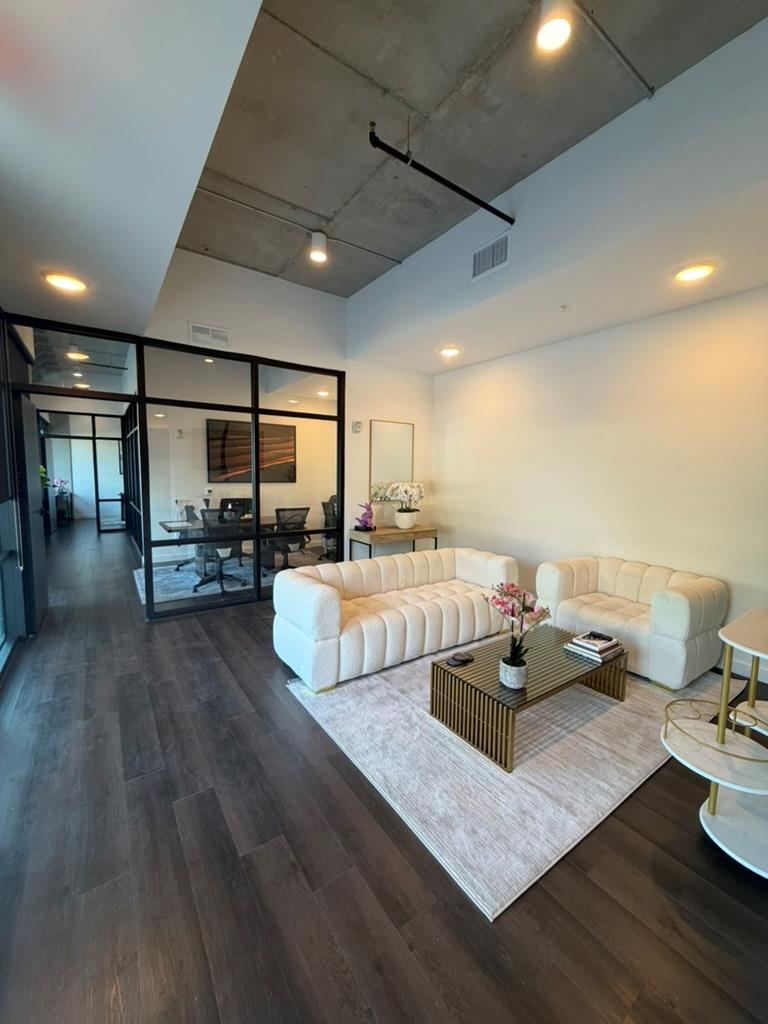Industrial concrete ceilings and rich hardwood fl