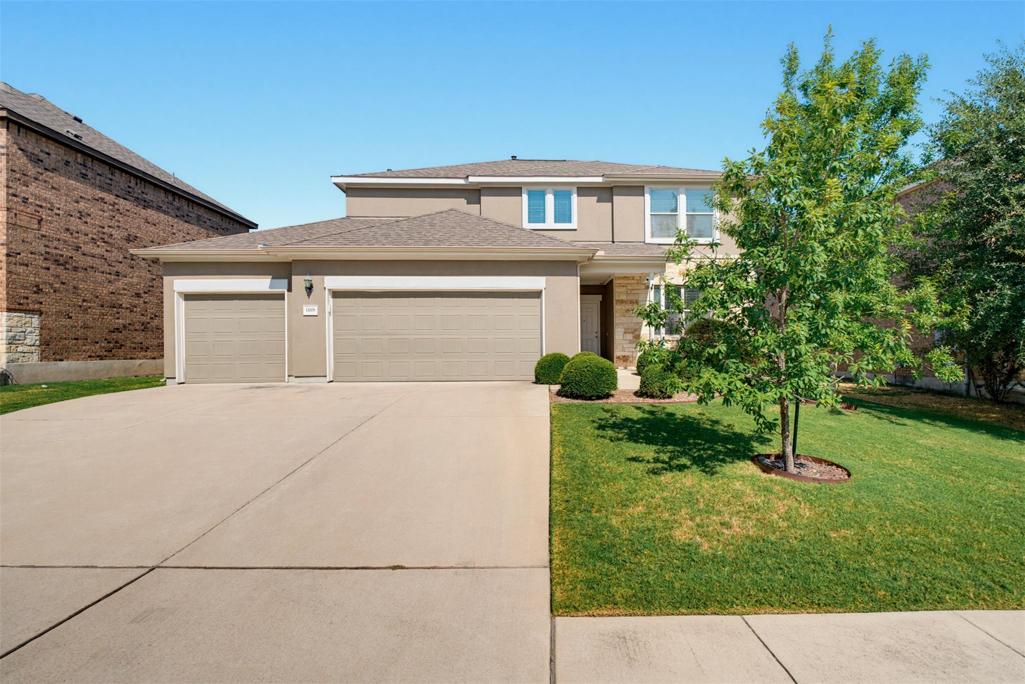 An inviting stone and stucco exterior anchors thi