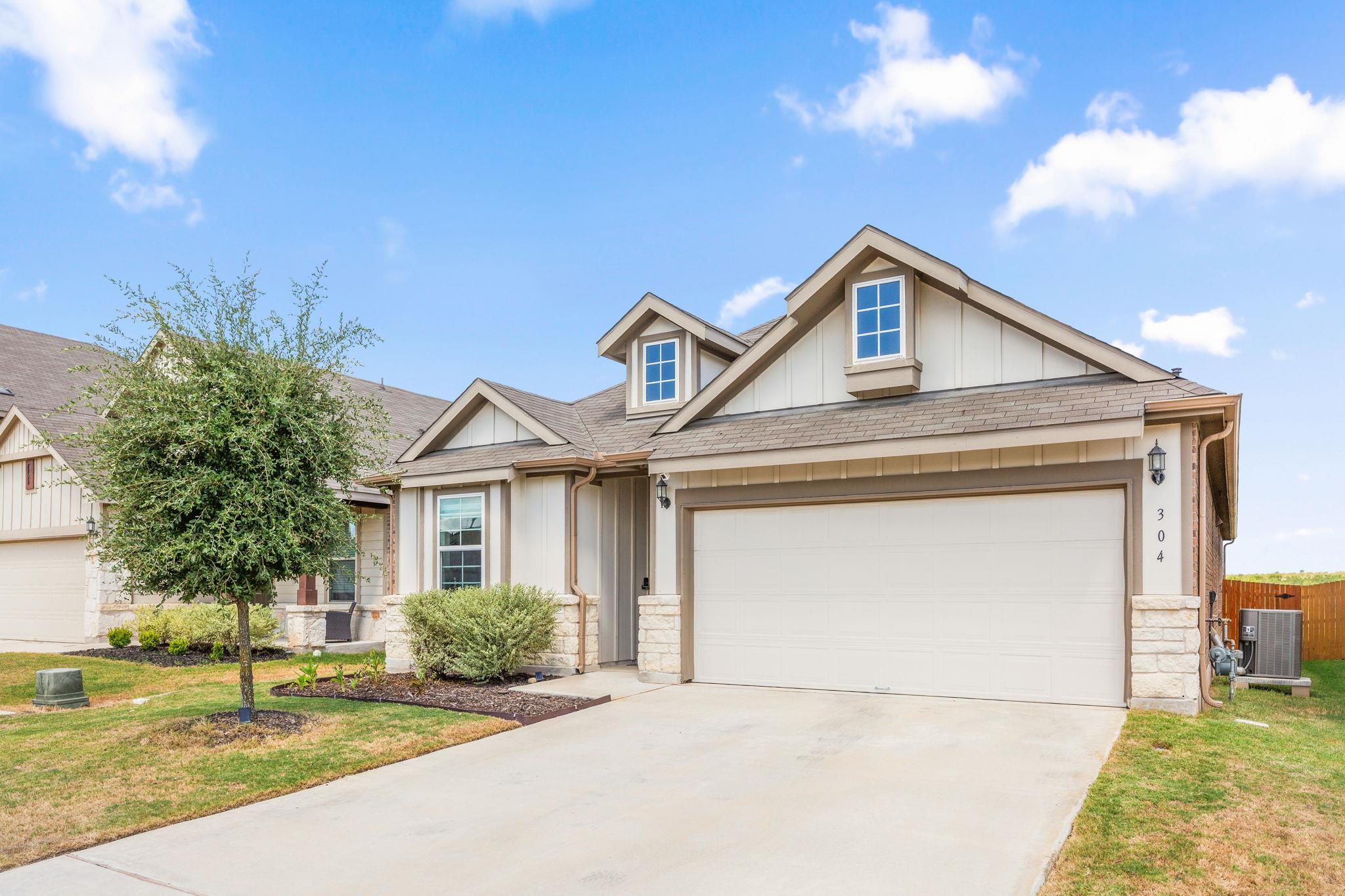 Gabled rooflines and stone accents define this mo