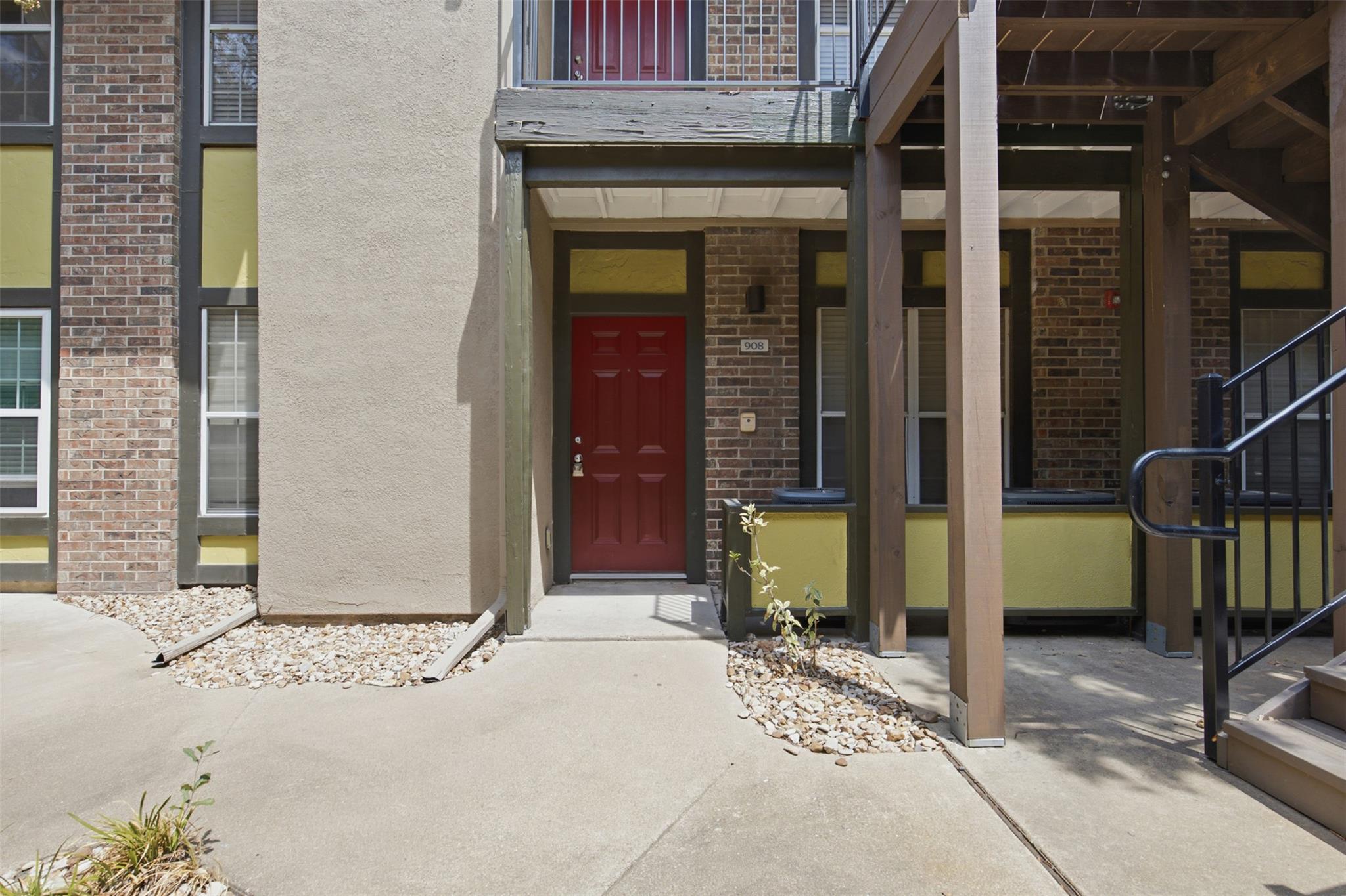 An inviting private entrance is bordered by class