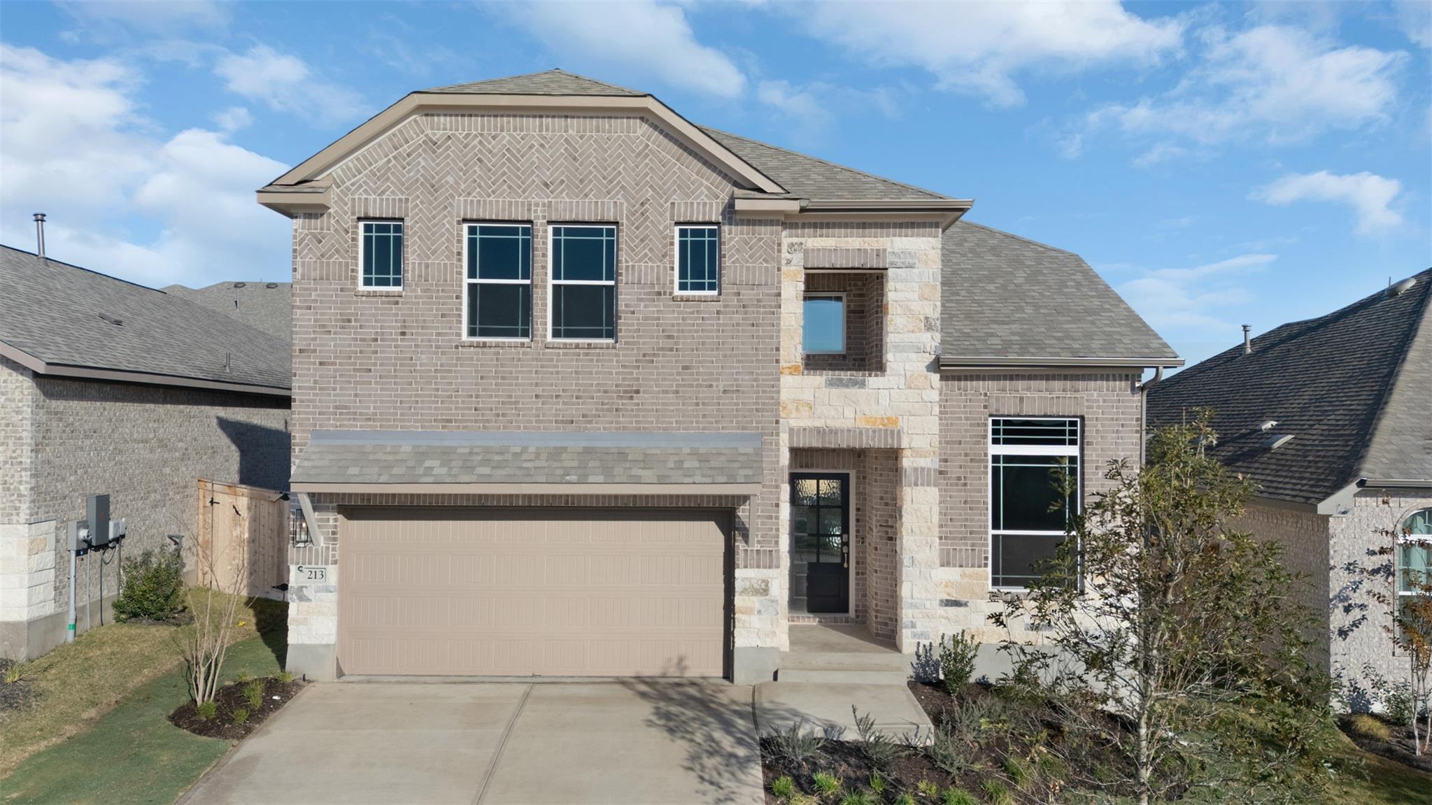A combination of brick and stone masonry defines 
