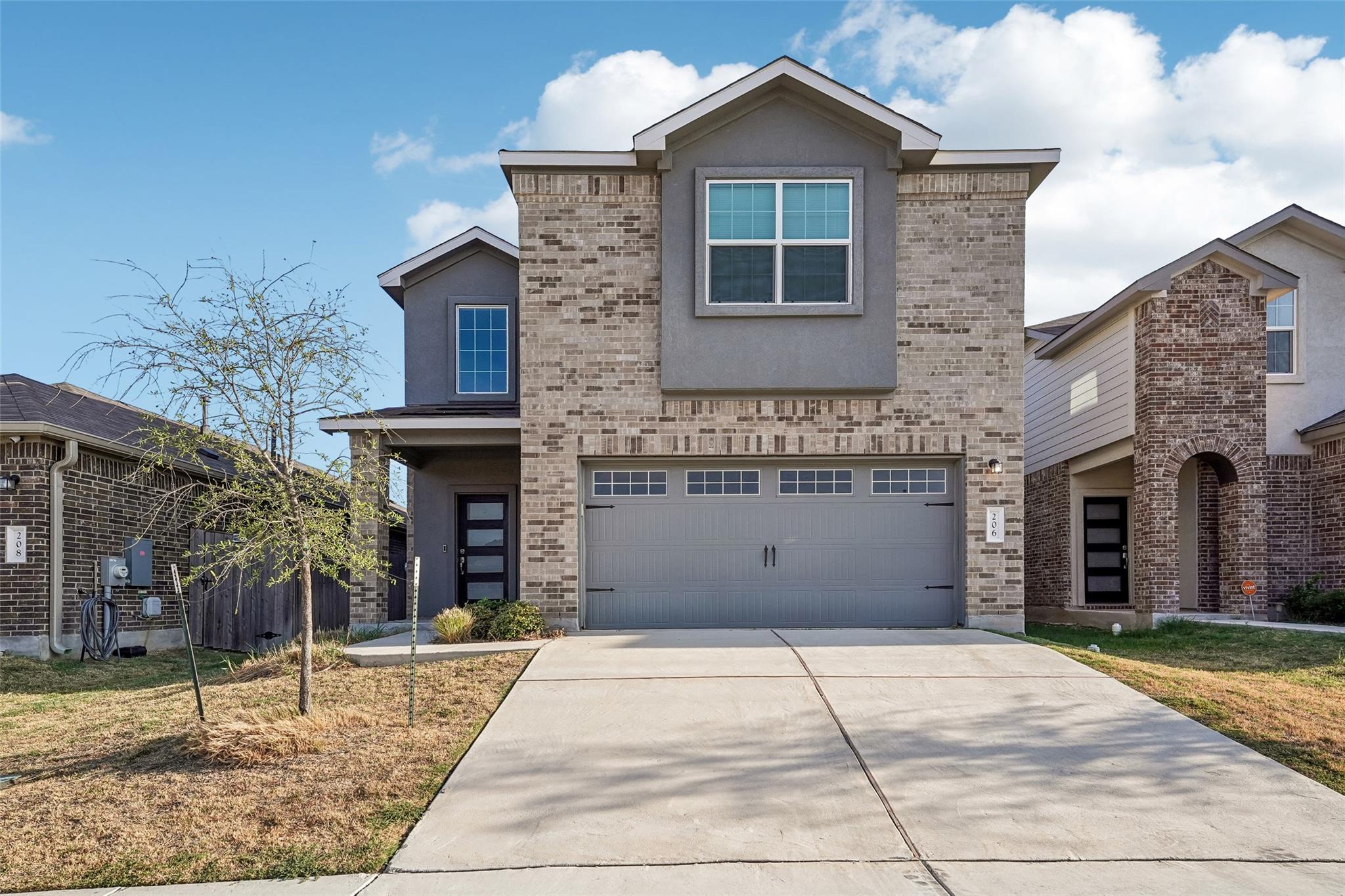 An inviting two-story brick elevation with an att