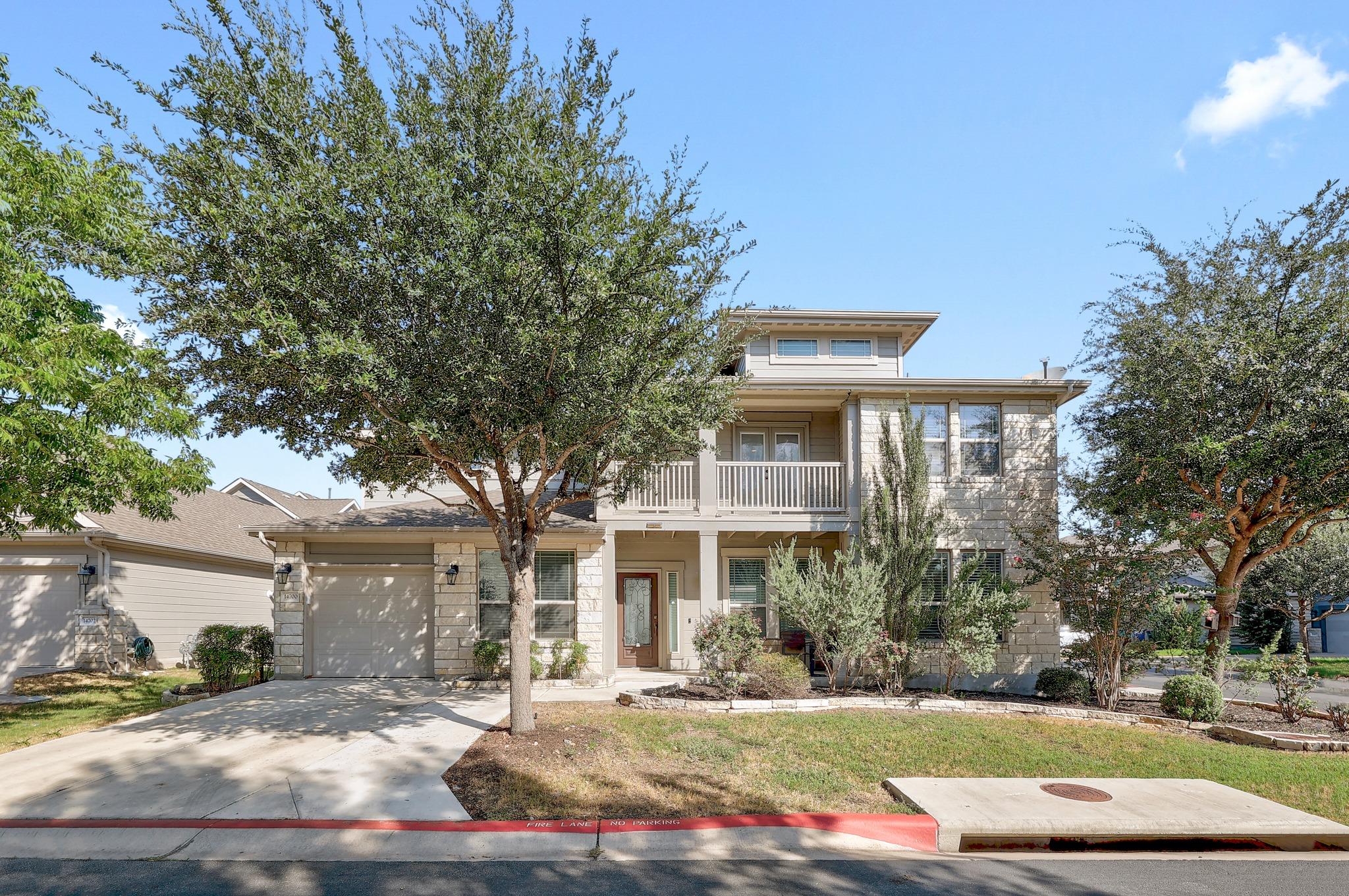Limestone masonry and a concrete driveway define 