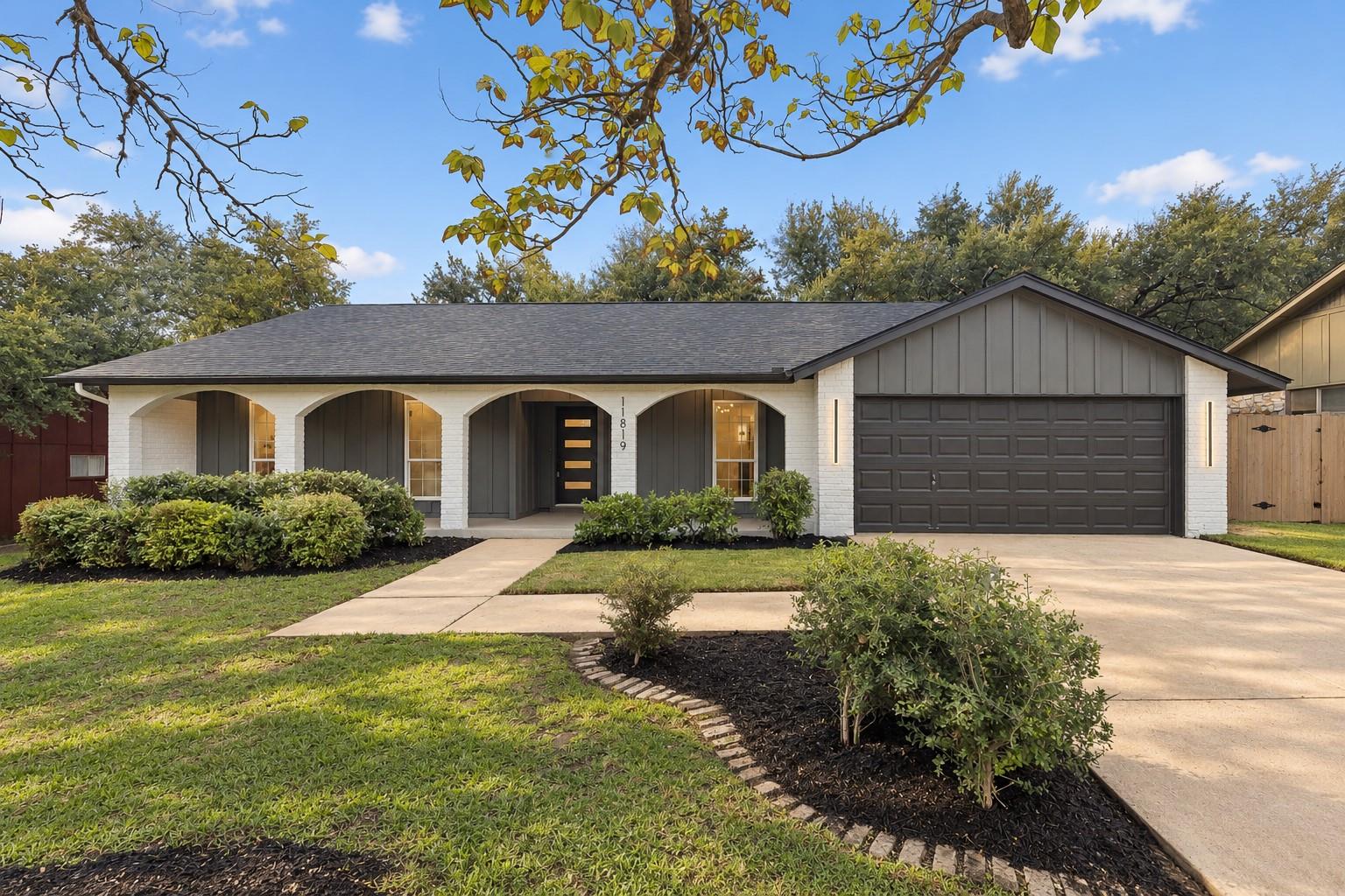 An arched front porch and attached double garage 