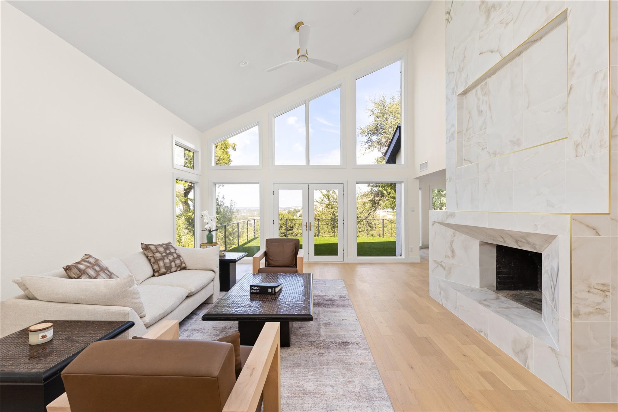 A grand stone fireplace anchors the soaring livin