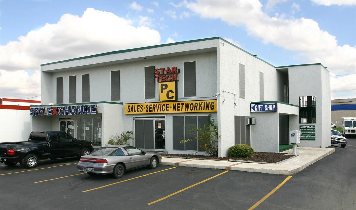 A prominent multi-tenant stucco building features