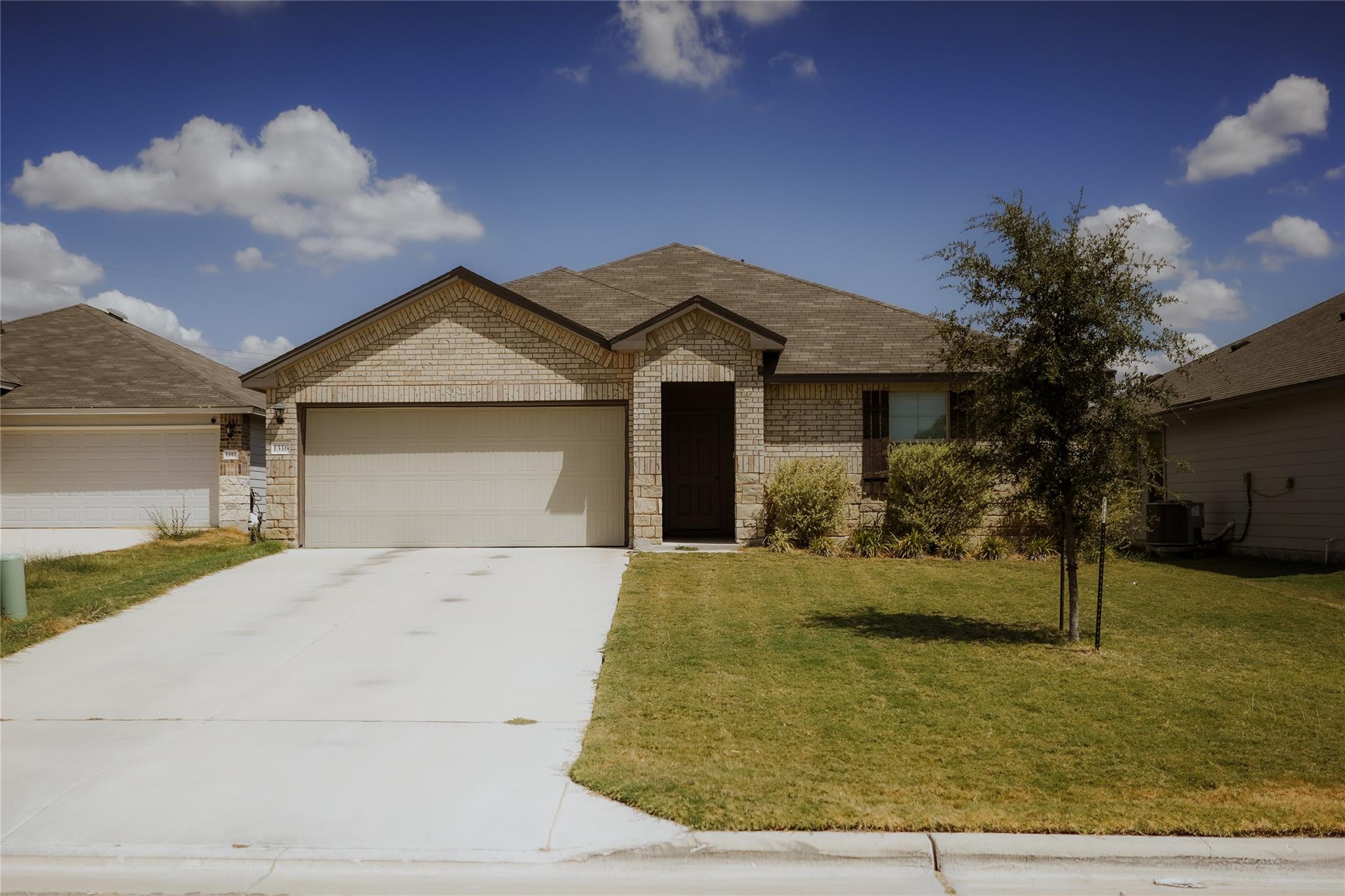 An attractive brick exterior features a spacious 