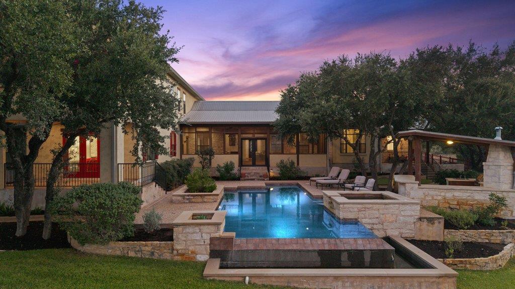 A sparkling swimming pool anchors the sprawling b