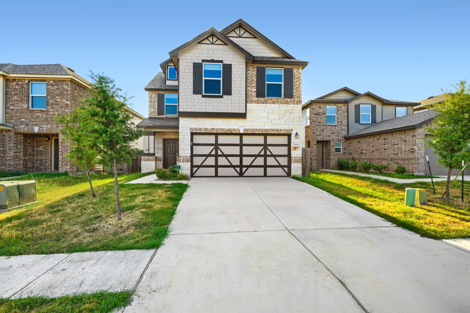 A wide concrete driveway leads directly to a mode