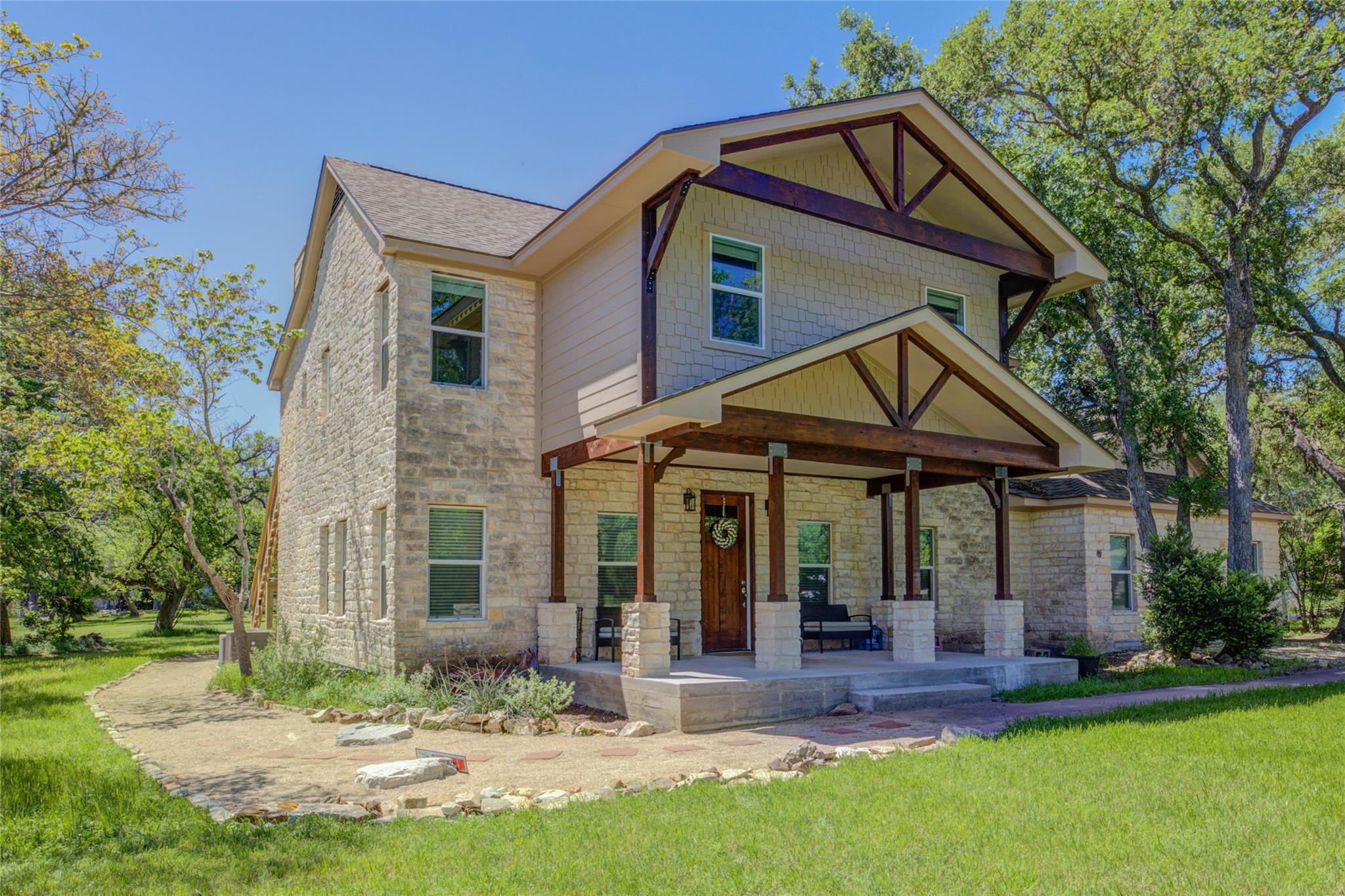 Exquisite stone and wood accents define this welc