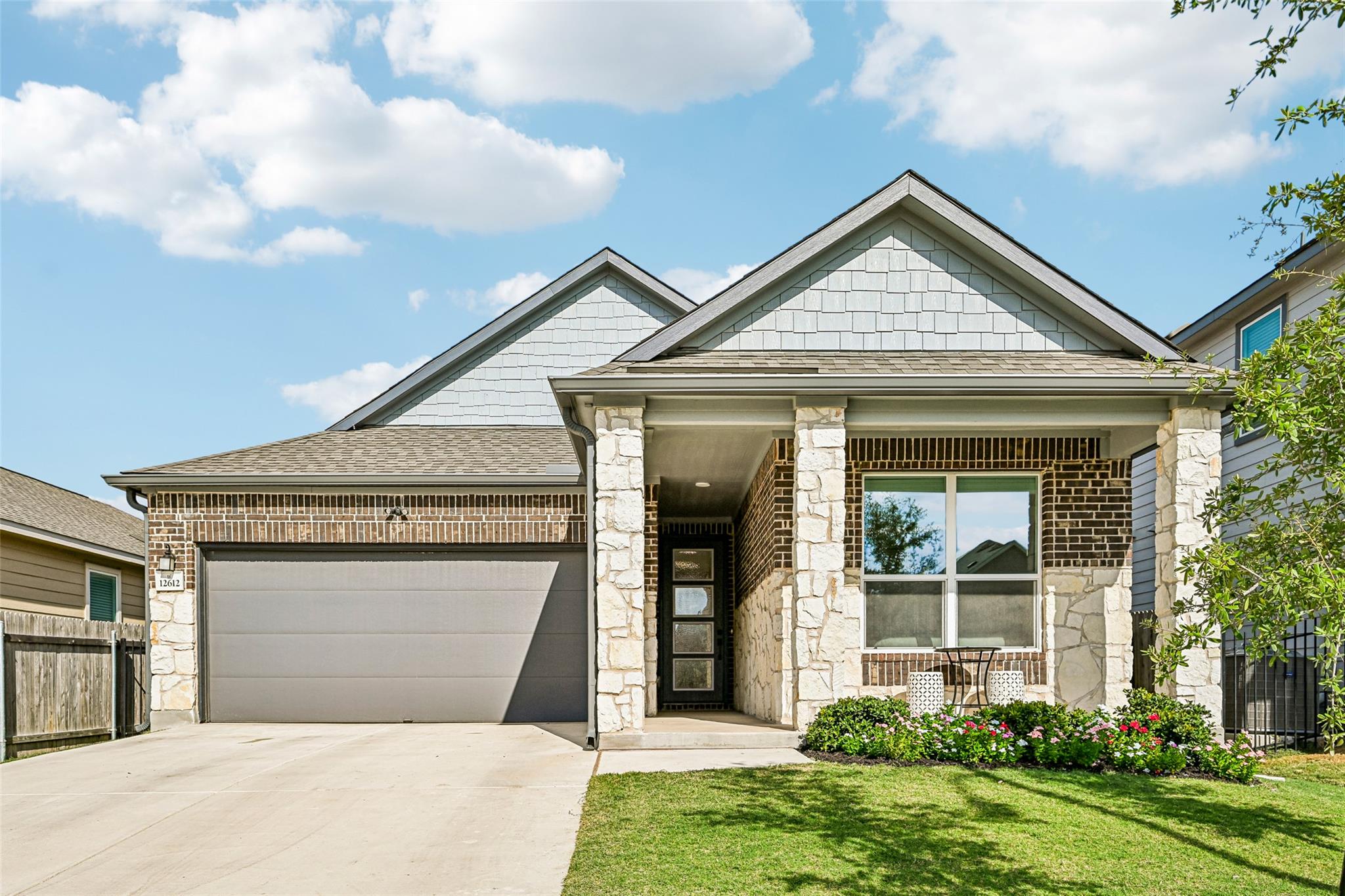A striking combination of brick, stone, and shake