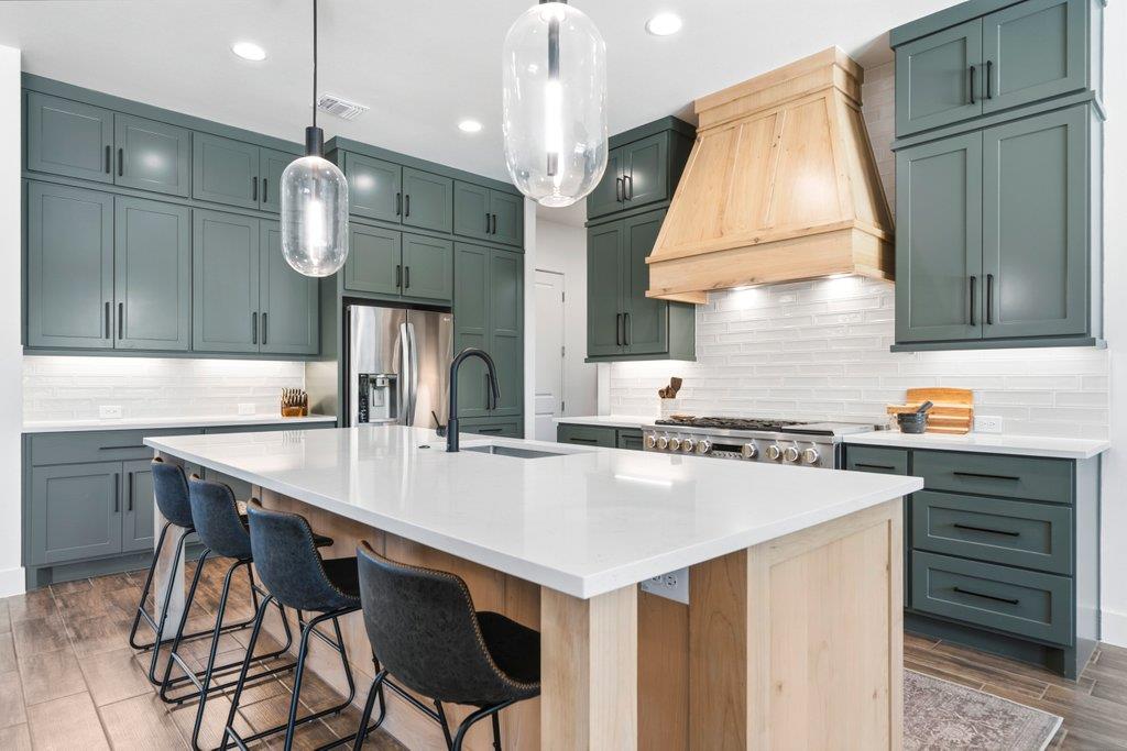 A spacious kitchen highlights dual-toned cabinetr