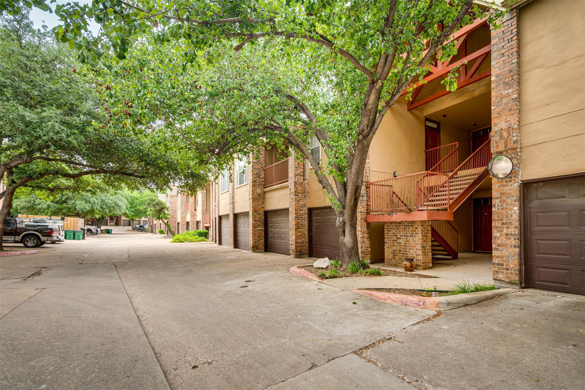 Mature trees shade the multi-level exterior featu