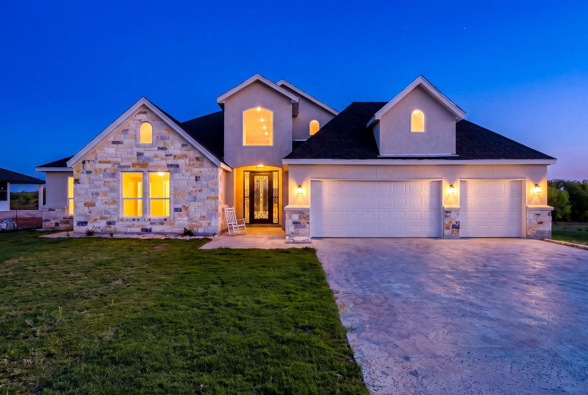 An inviting exterior balances classic stone accen