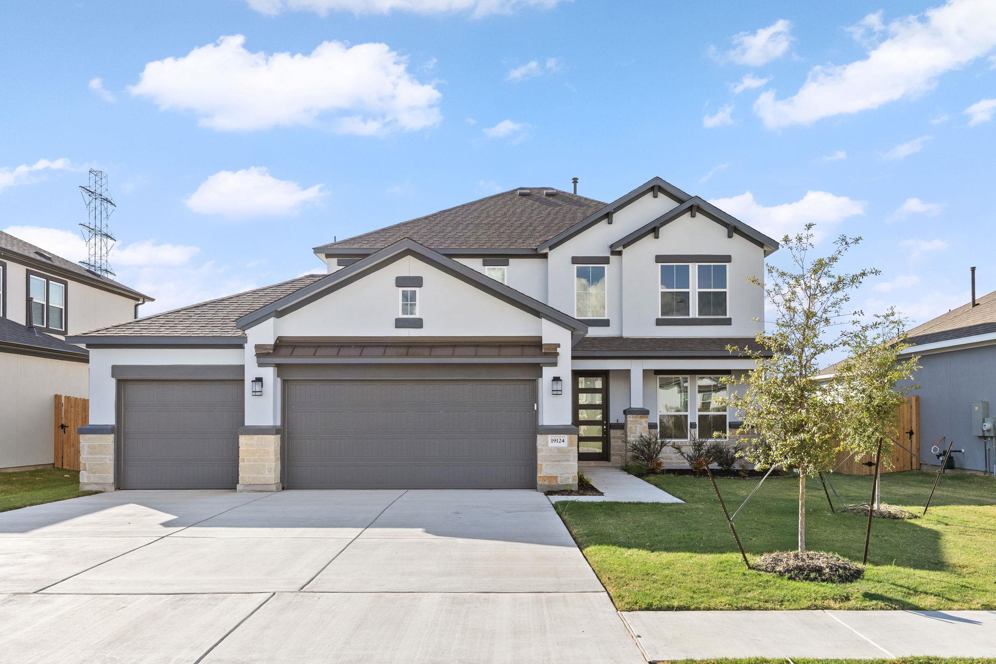 A classic concrete driveway leads to this modern 