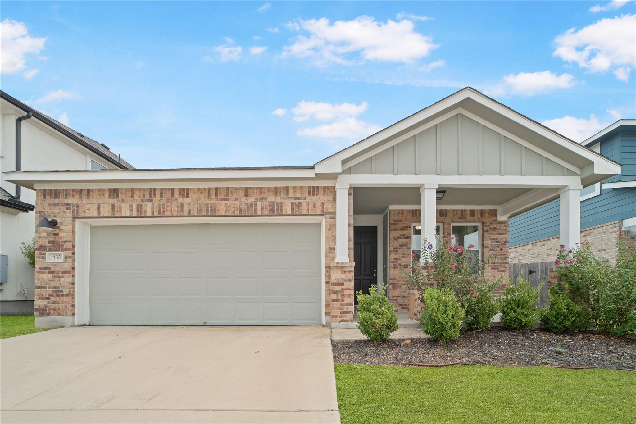Brick veneer and vertical siding create classic c