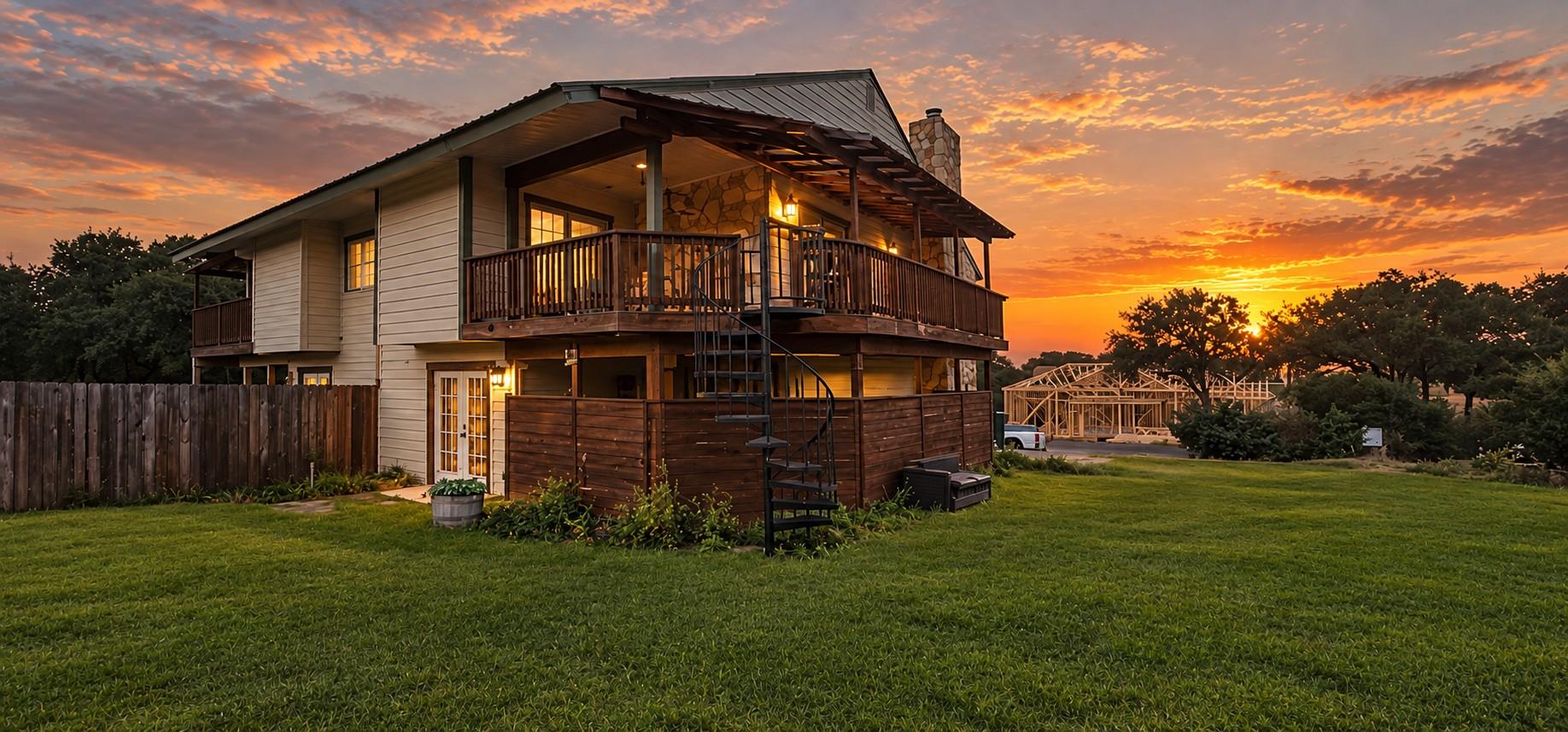 A spacious elevated deck overlooks the lush lawn 