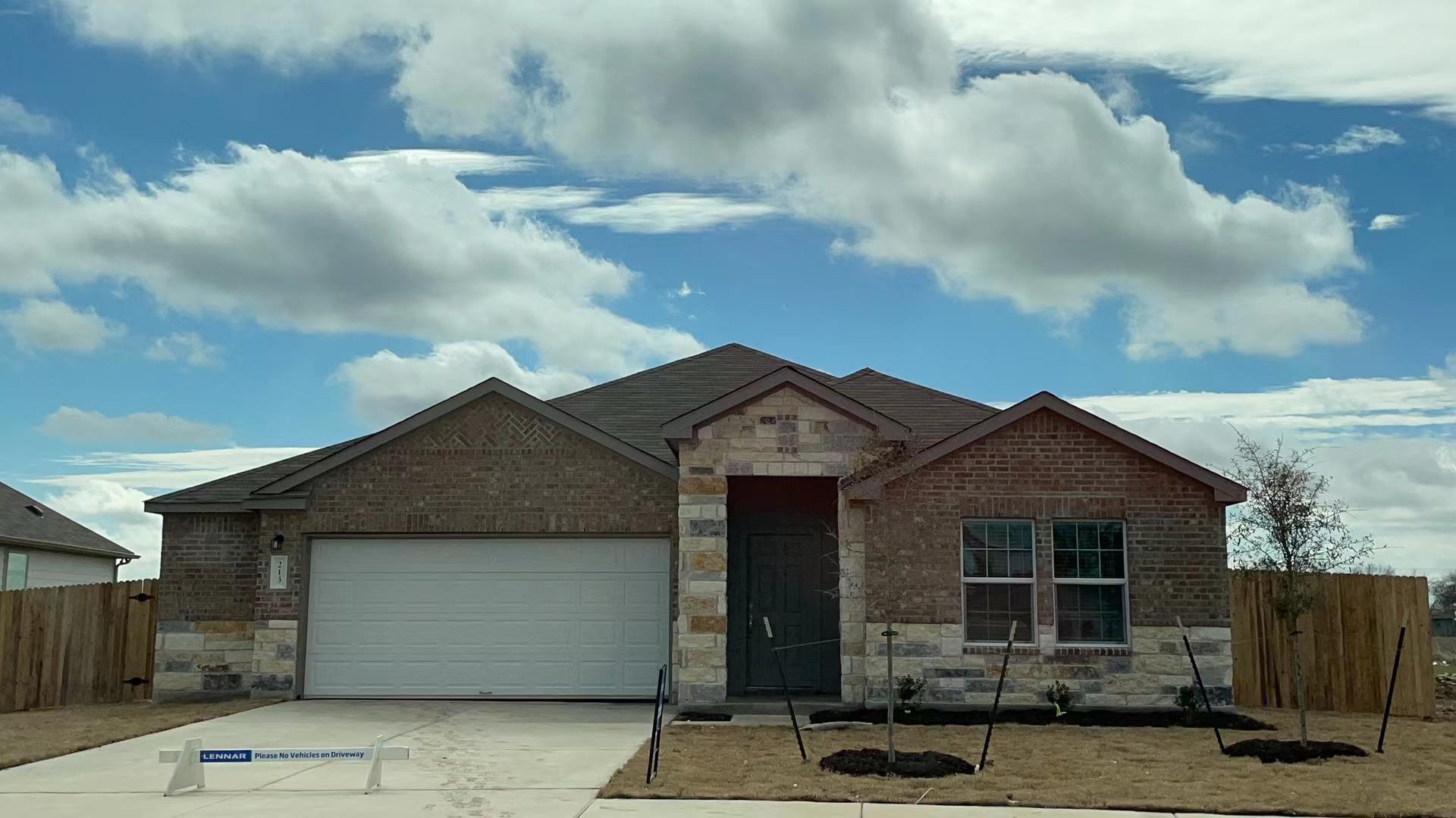 Brick and stone accents define this modern single
