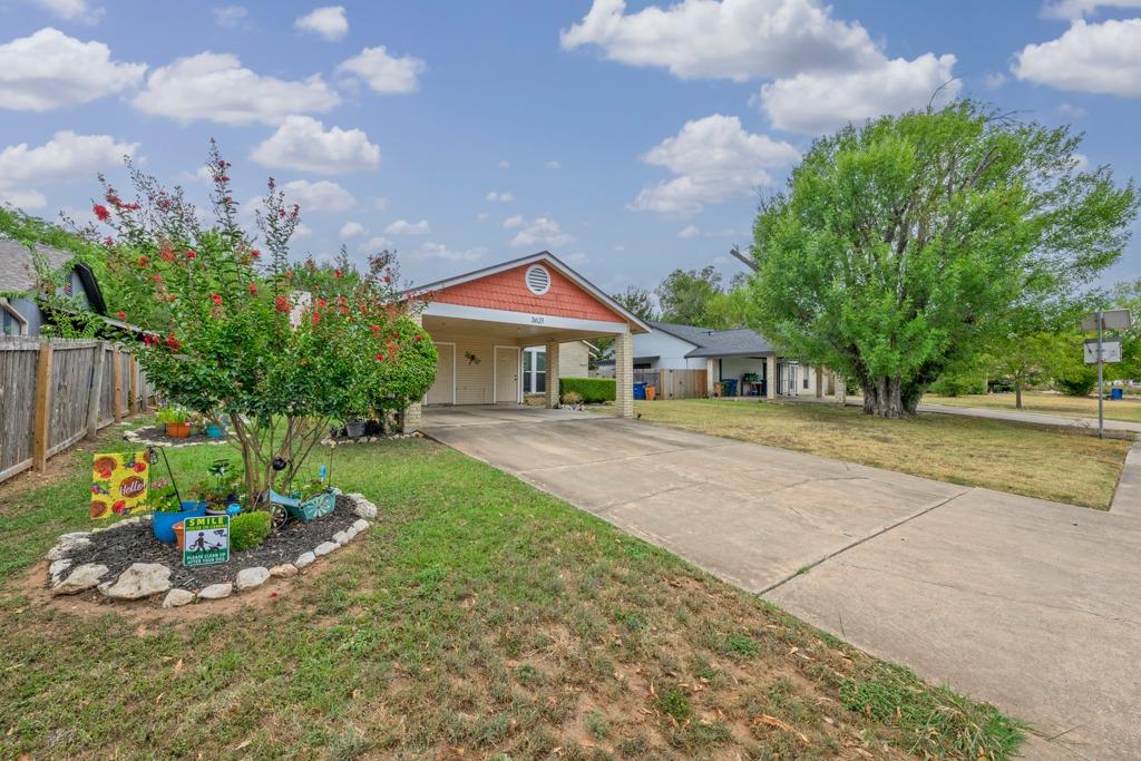A spacious concrete driveway leads directly to a 