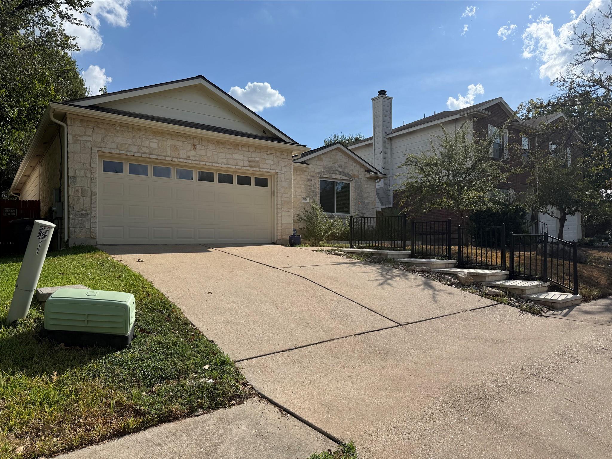 Stone and siding exterior showcases a two-car gar