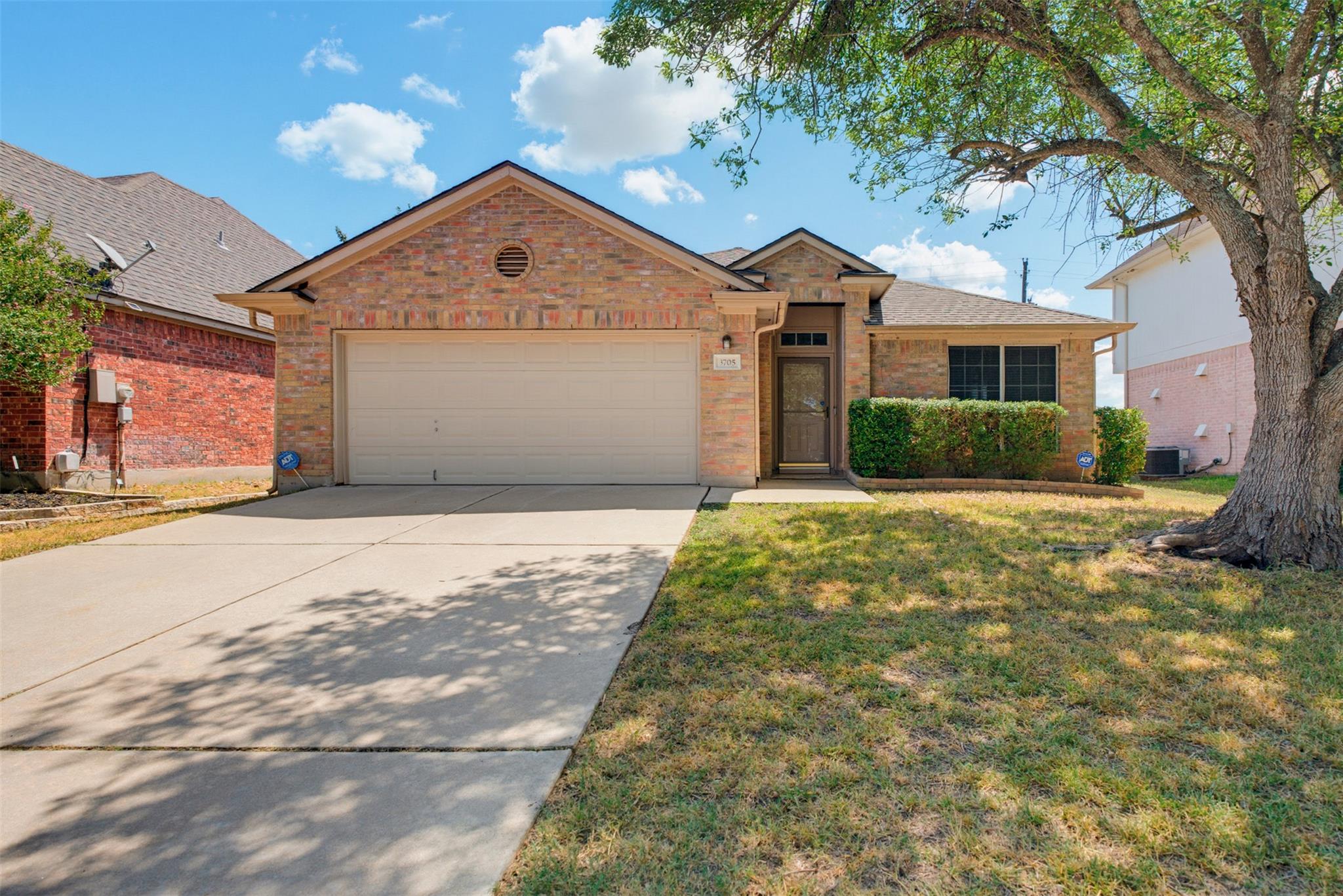 Brick exterior detailing and a concrete driveway 