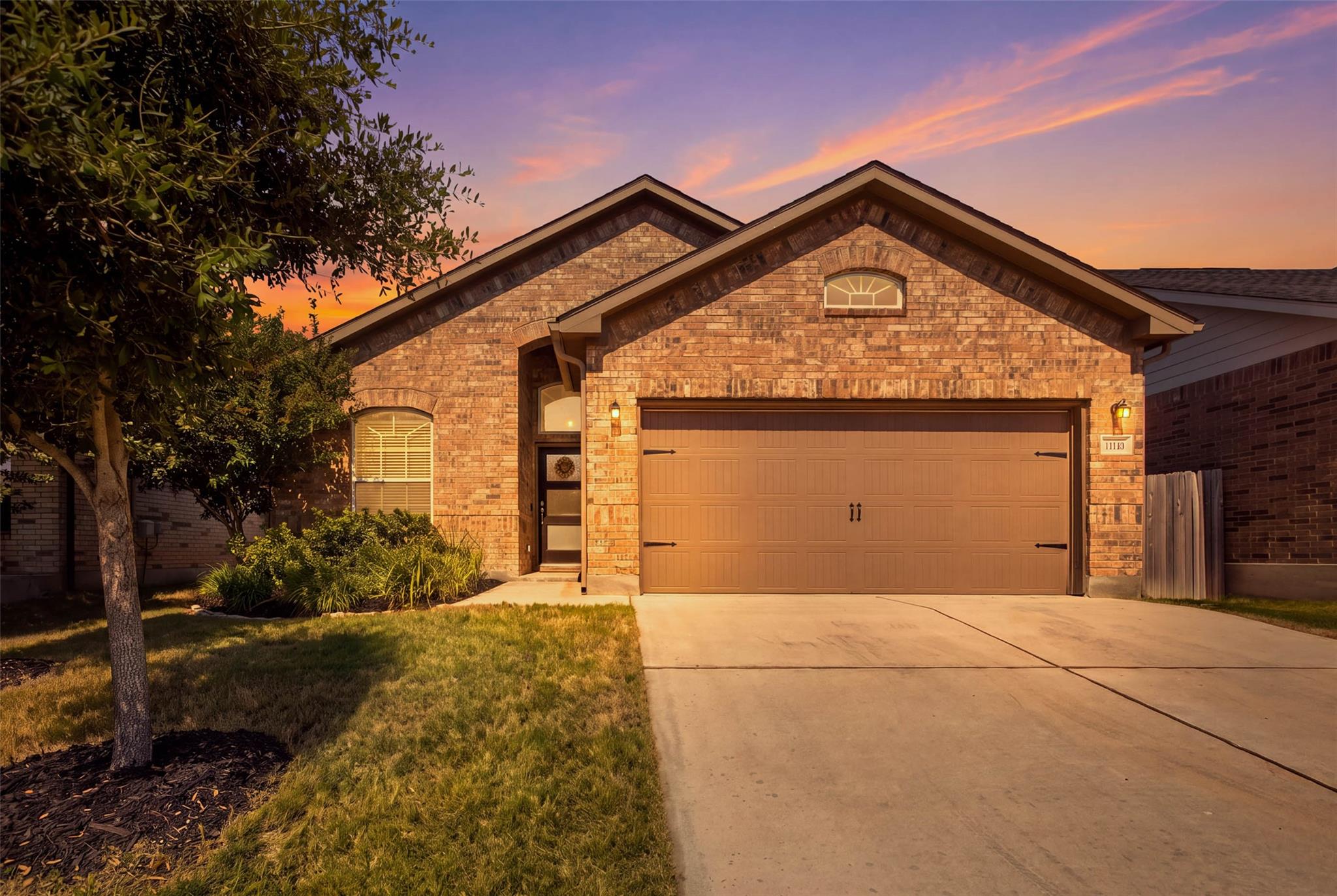 Brick exterior detailing and a spacious concrete 