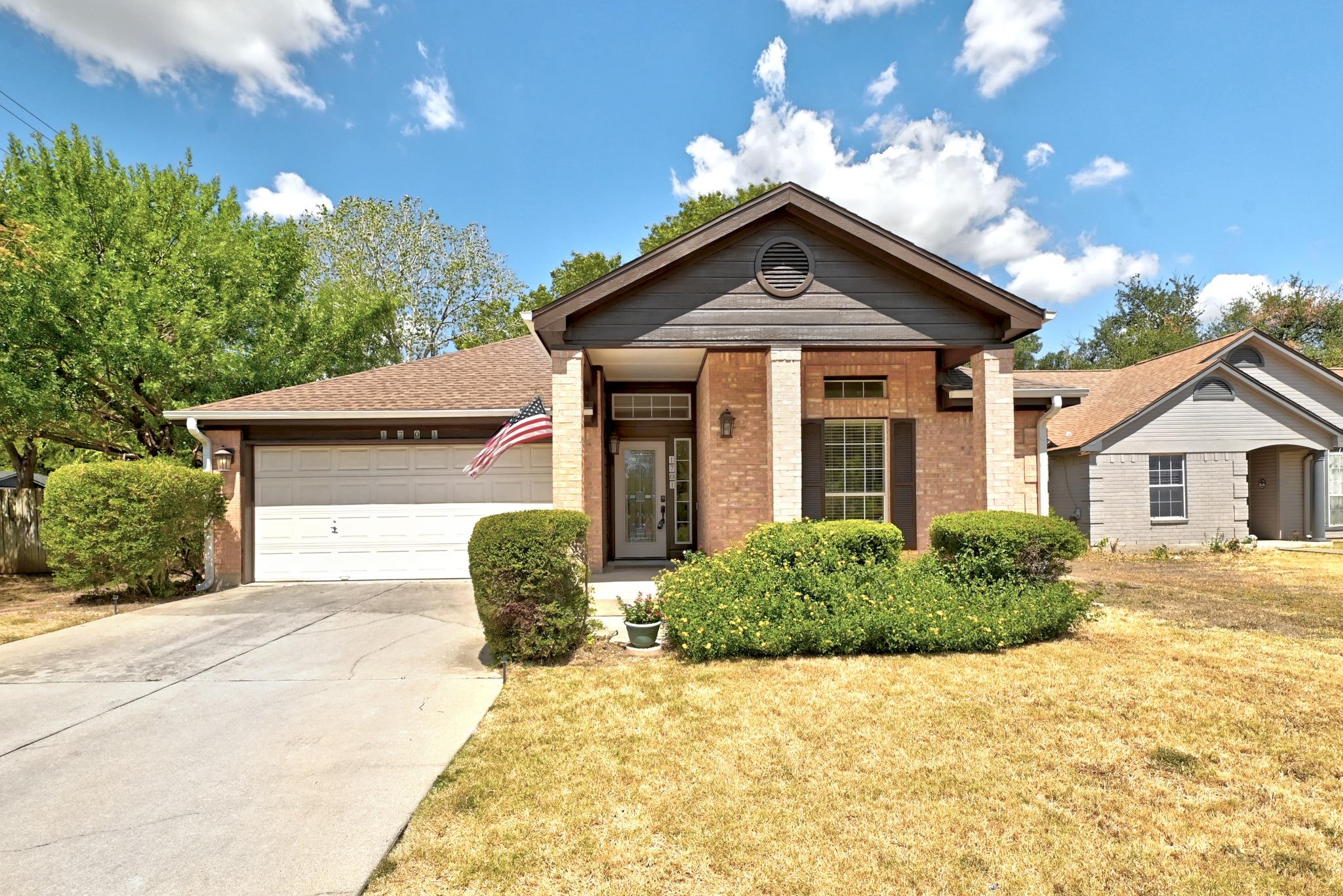 A classic brick exterior and a concrete driveway 