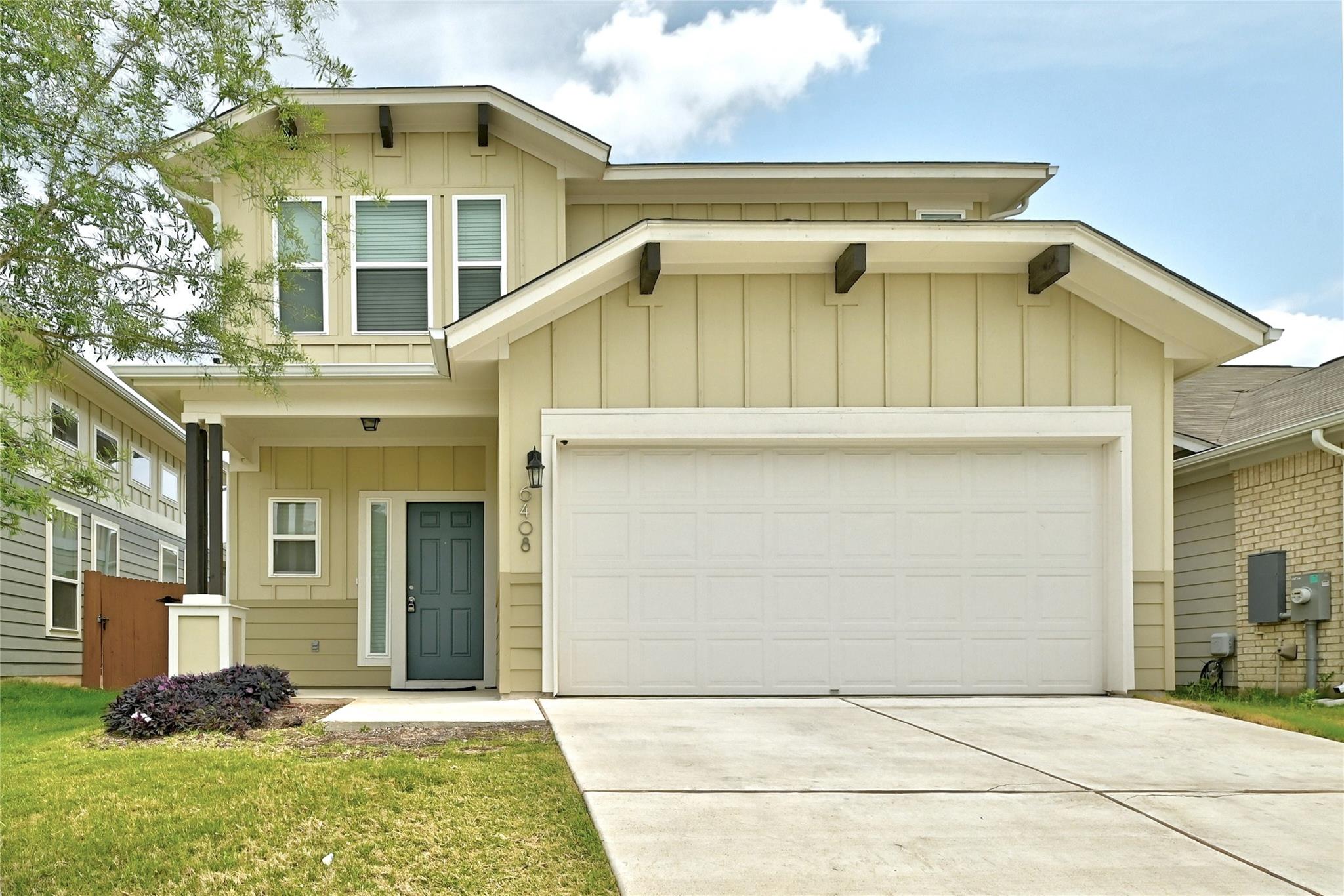 A spacious two-car garage sits beside the covered