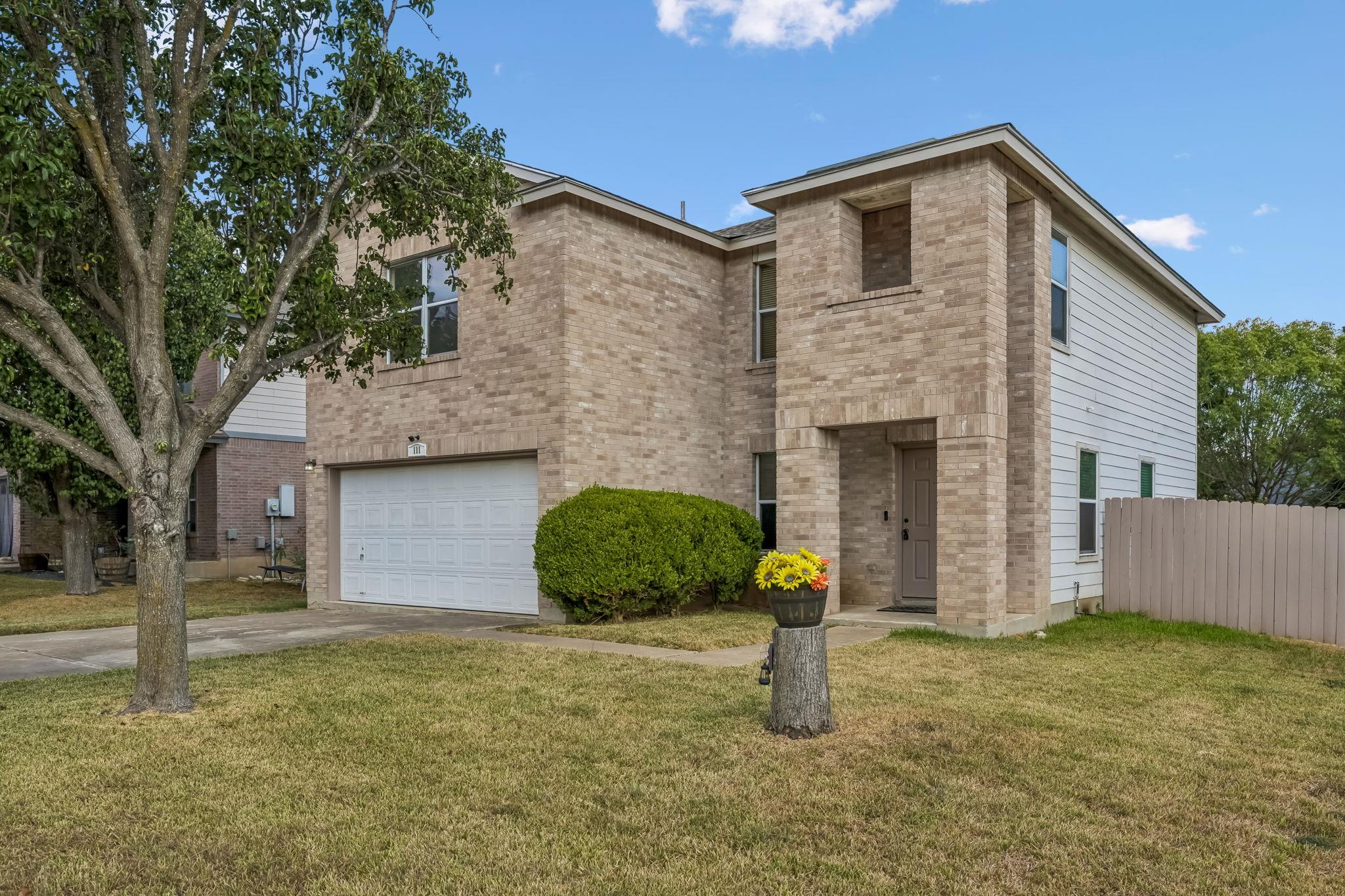 Classic brick accents and vertical siding define 