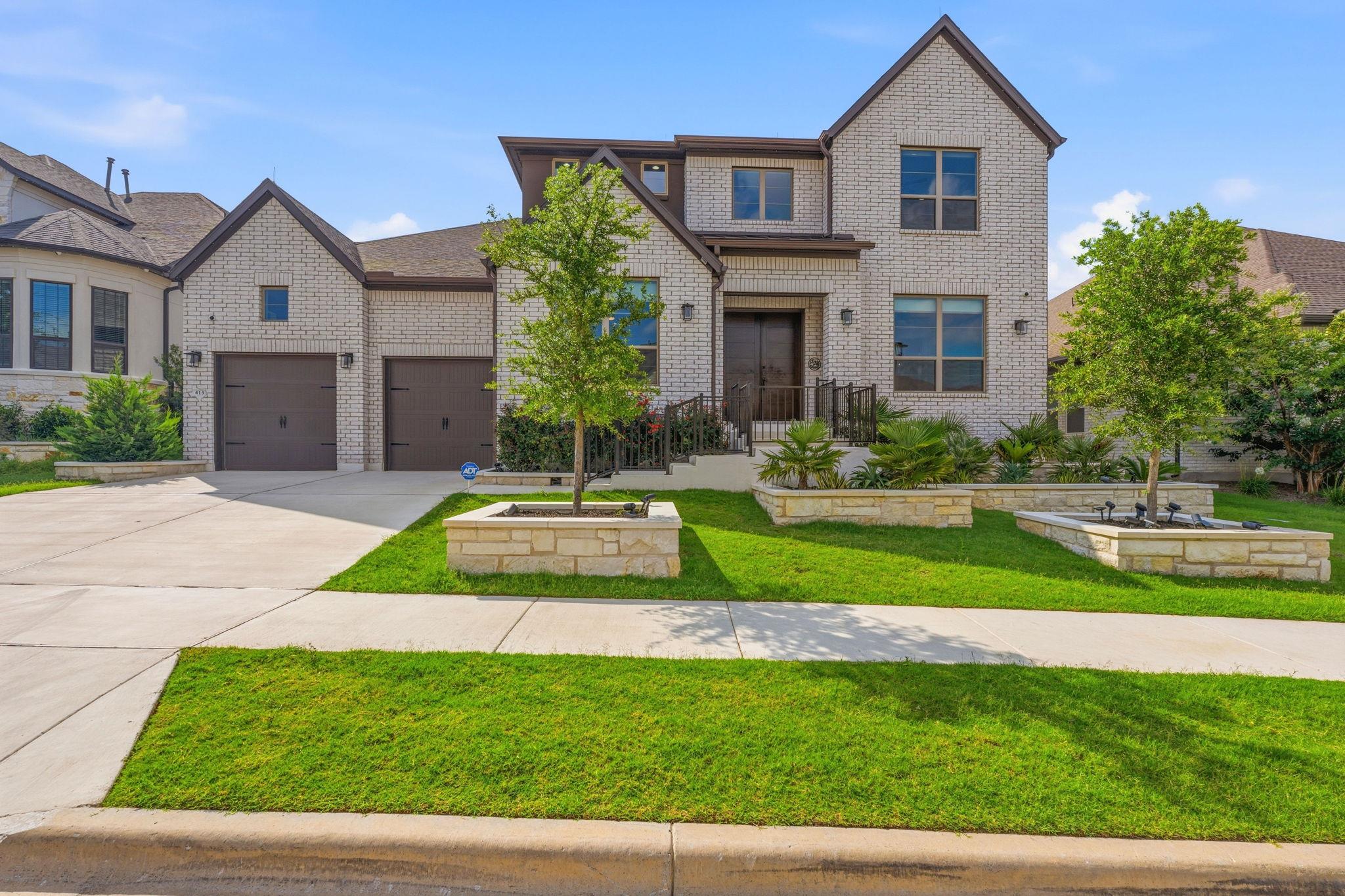 A light-colored brick exterior presents timeless 