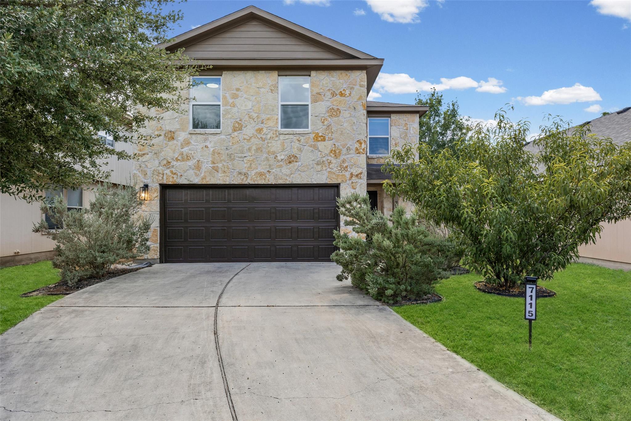 A curved concrete driveway leads to the integrate