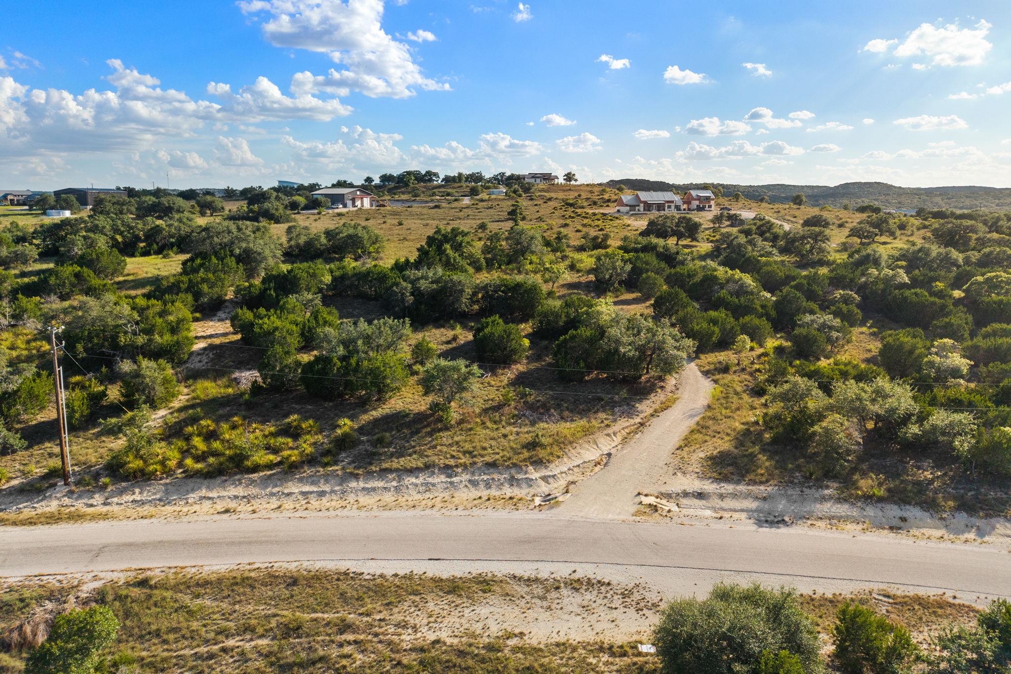 Rolling hillsides covered in native trees stretch