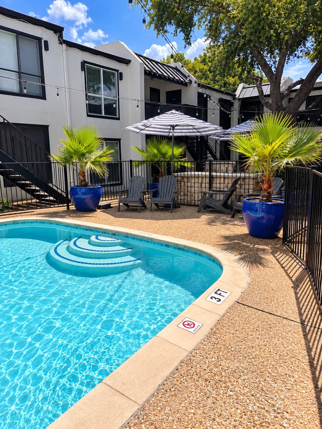 An inviting swimming pool area sits surrounded by