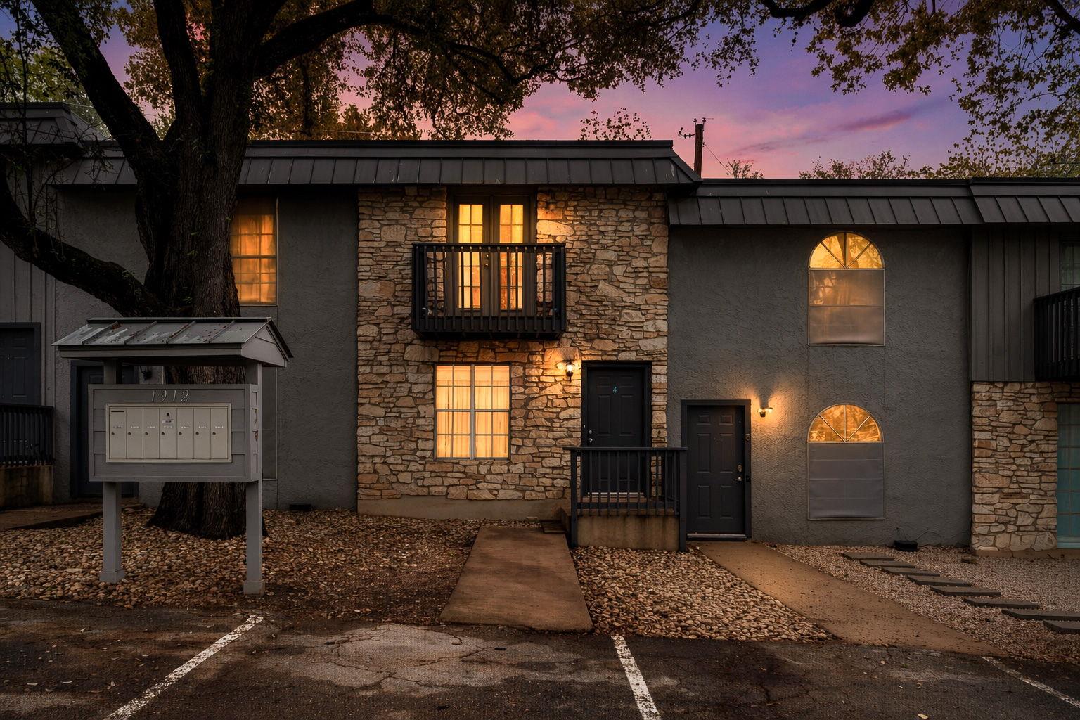 Natural stone accents and tall arched windows enh