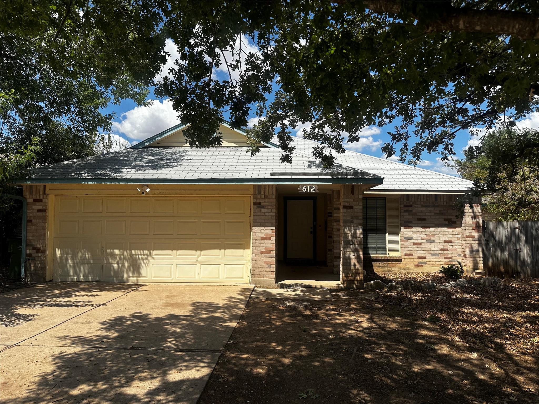 Mature trees shade the brick facade of this class