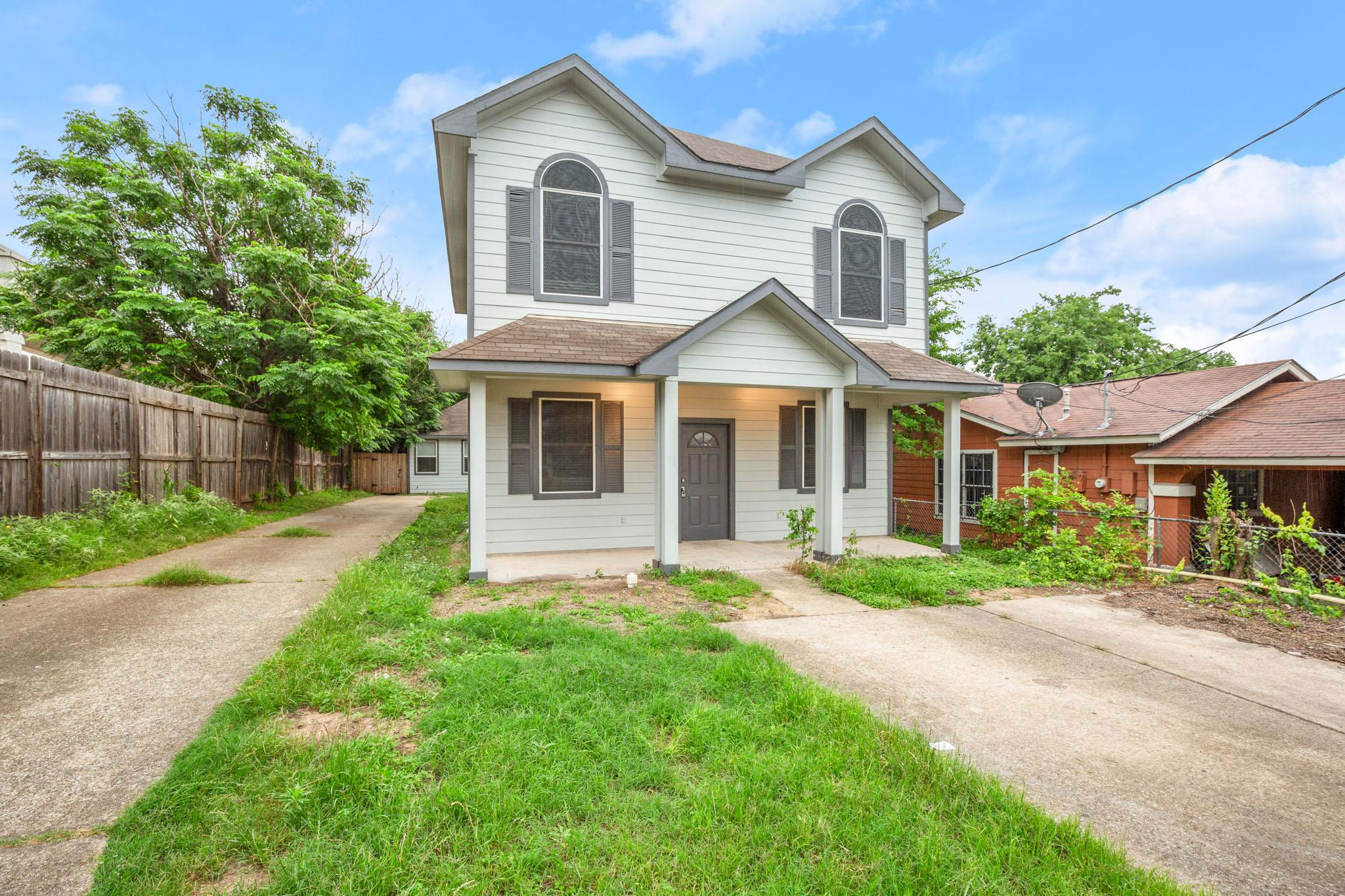 A welcoming front porch and classic siding define
