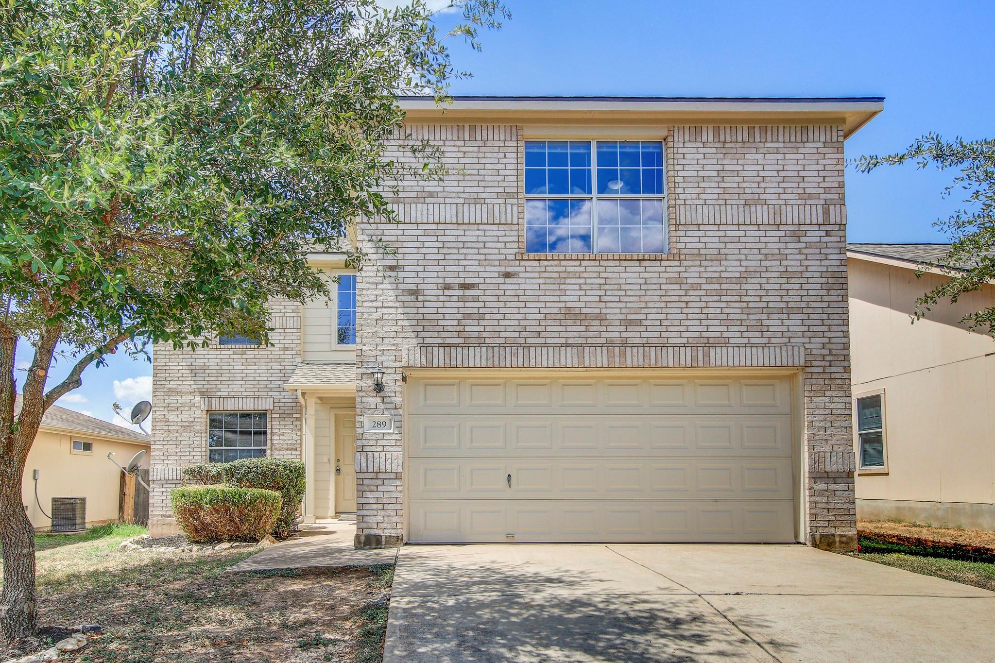 A classic brick exterior and private driveway lea